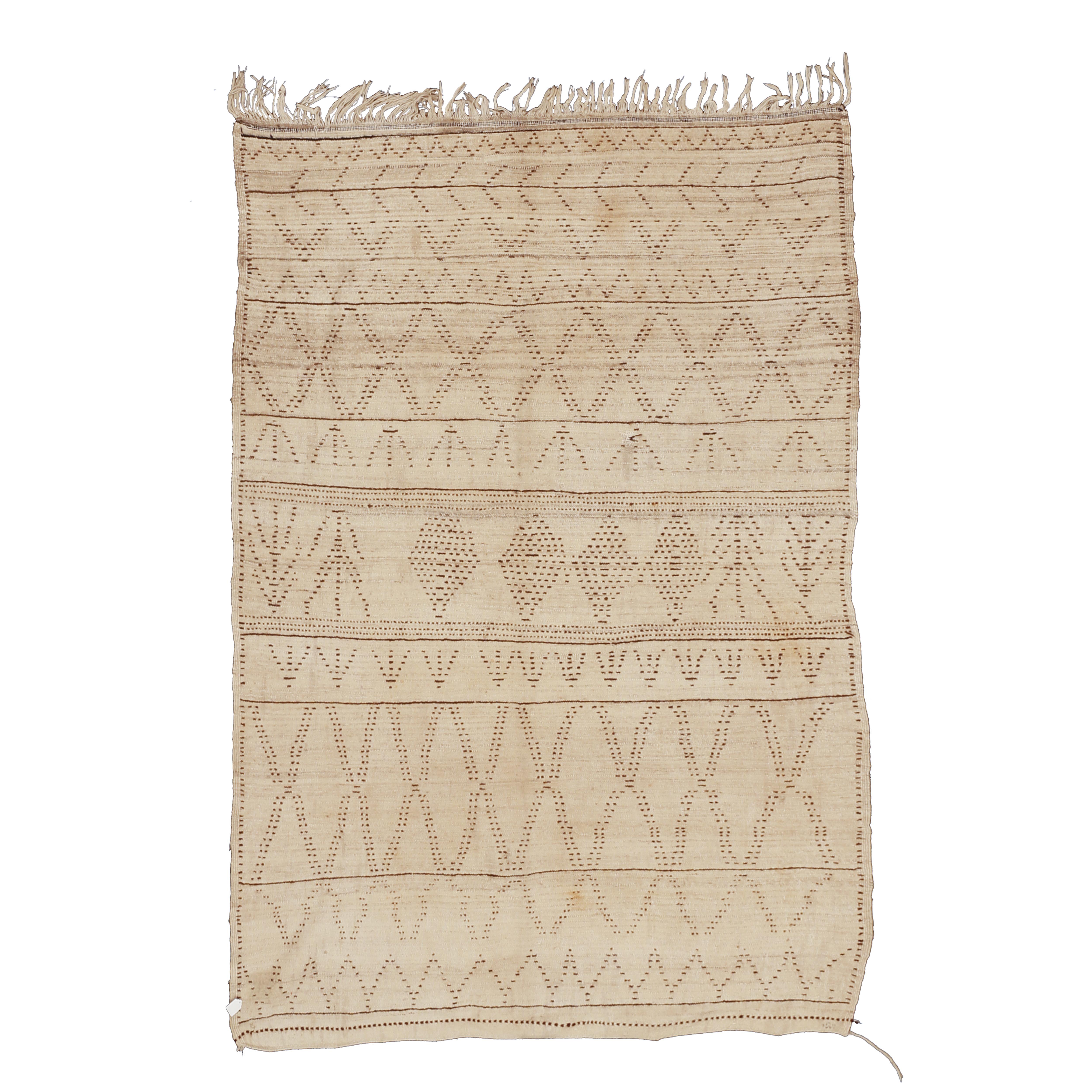 Woven with natural, undyed wool, this rug belongs to the earliest group of Azilal weavings and the first ones to appear on the market around the turn of the Millennium. Azilal rugs share some design features with some of the ivory ground weavings