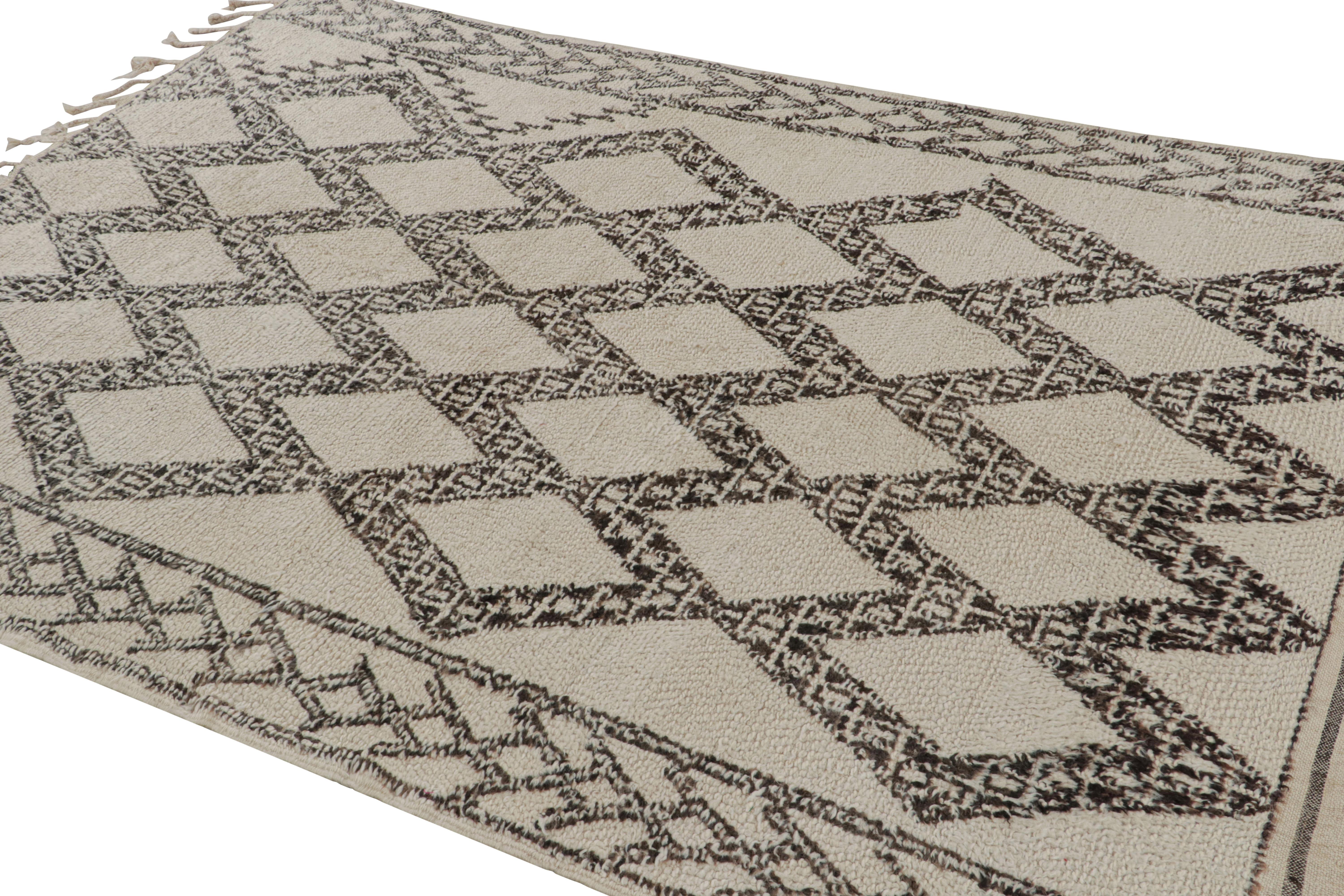 Hand-knotted in wool circa 1950-1960, this vintage 6x9 Moroccan rug is believed to hail from the Azilal tribe. 

On the Design: 

This rug carries a repetition of the prominent diamond lozenge motifs in the primitivist Berber style lending an