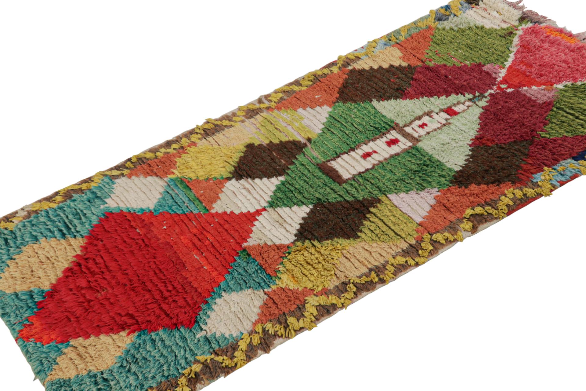 Hand-knotted in wool circa 1940-1950, this 3x6 vintage Moroccan runner is believed to hail from the Azilal tribe. 

On the Design:

This piece enjoys whimsical tones of red blue, green and brown in lozenges and other primitivist Berber geometric