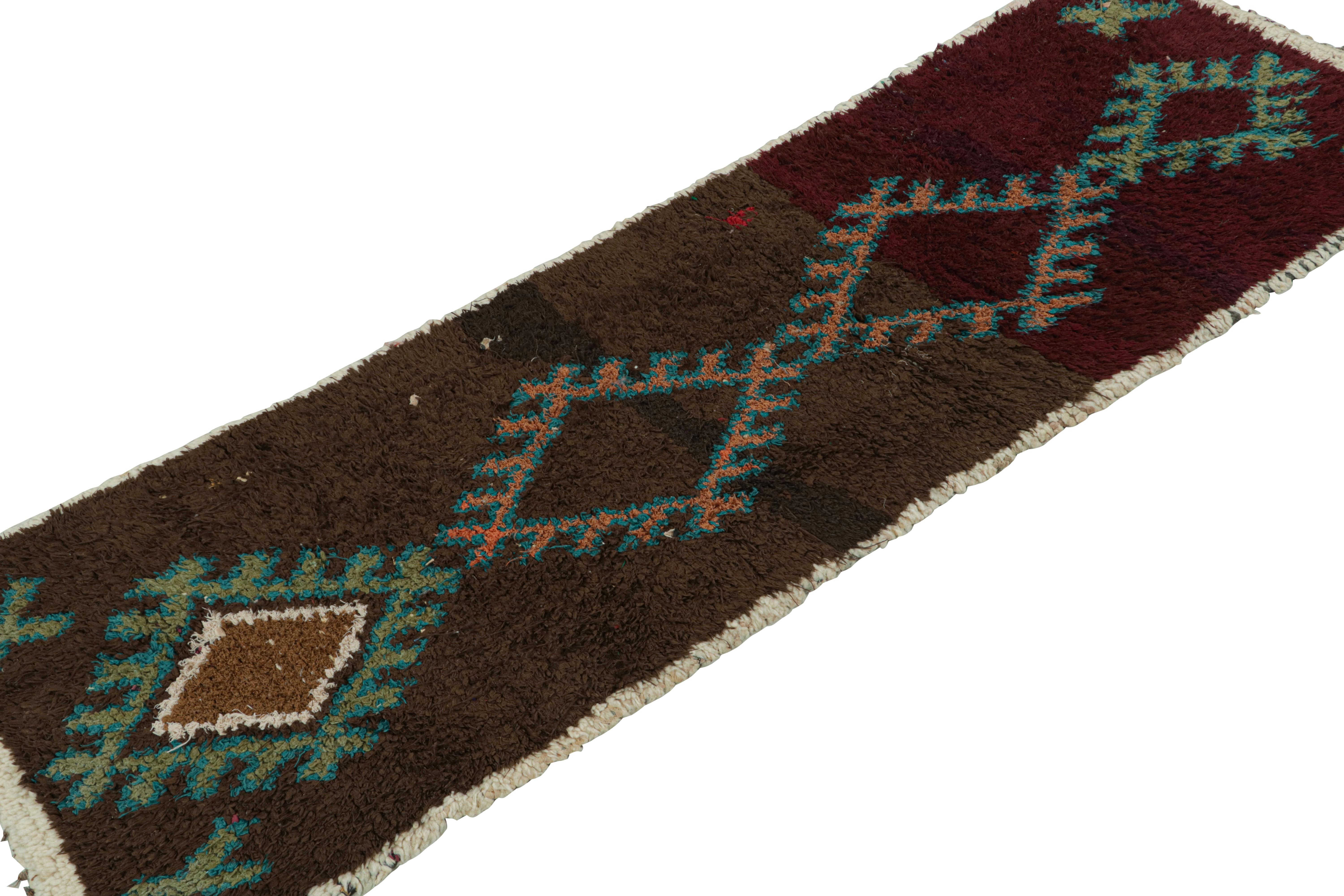 Hand-knotted in wool and cotton, circa 1950-1960, this 2x6 vintage Moroccan runner rug is believed to hail from the Azilal tribe. 

On the Design: 

This piece enjoys a lush high pile with polychromatic primitivist Berber geometric diamond medallion