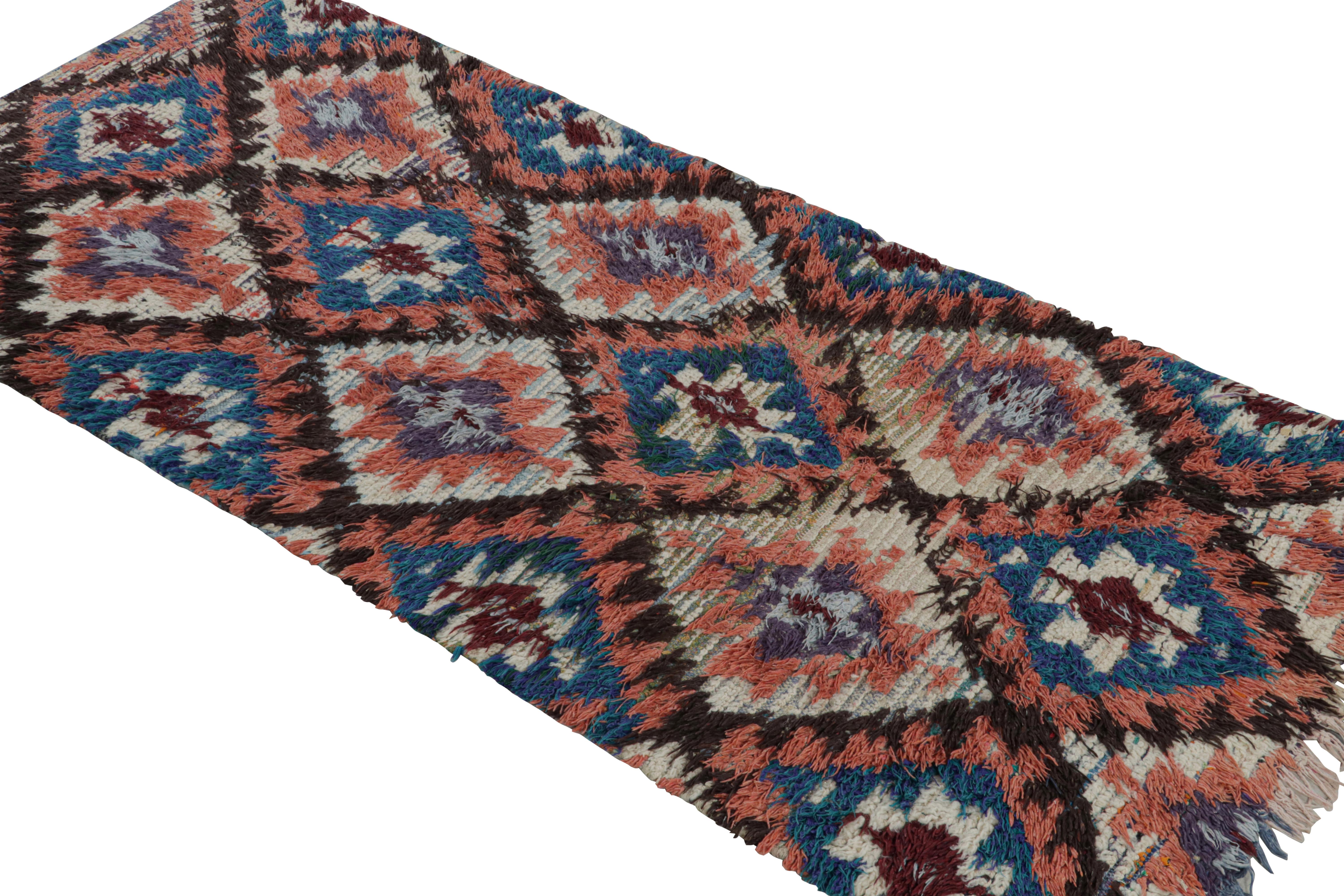 Hand-knotted in wool, circa 1950-1960, this 3x6 vintage Moroccan runner rug is believed to hail from the Azilal tribe. 

On the Design: 

This piece enjoys a lush high pile with polychromatic primitivist Berber geometric diamond medallion or