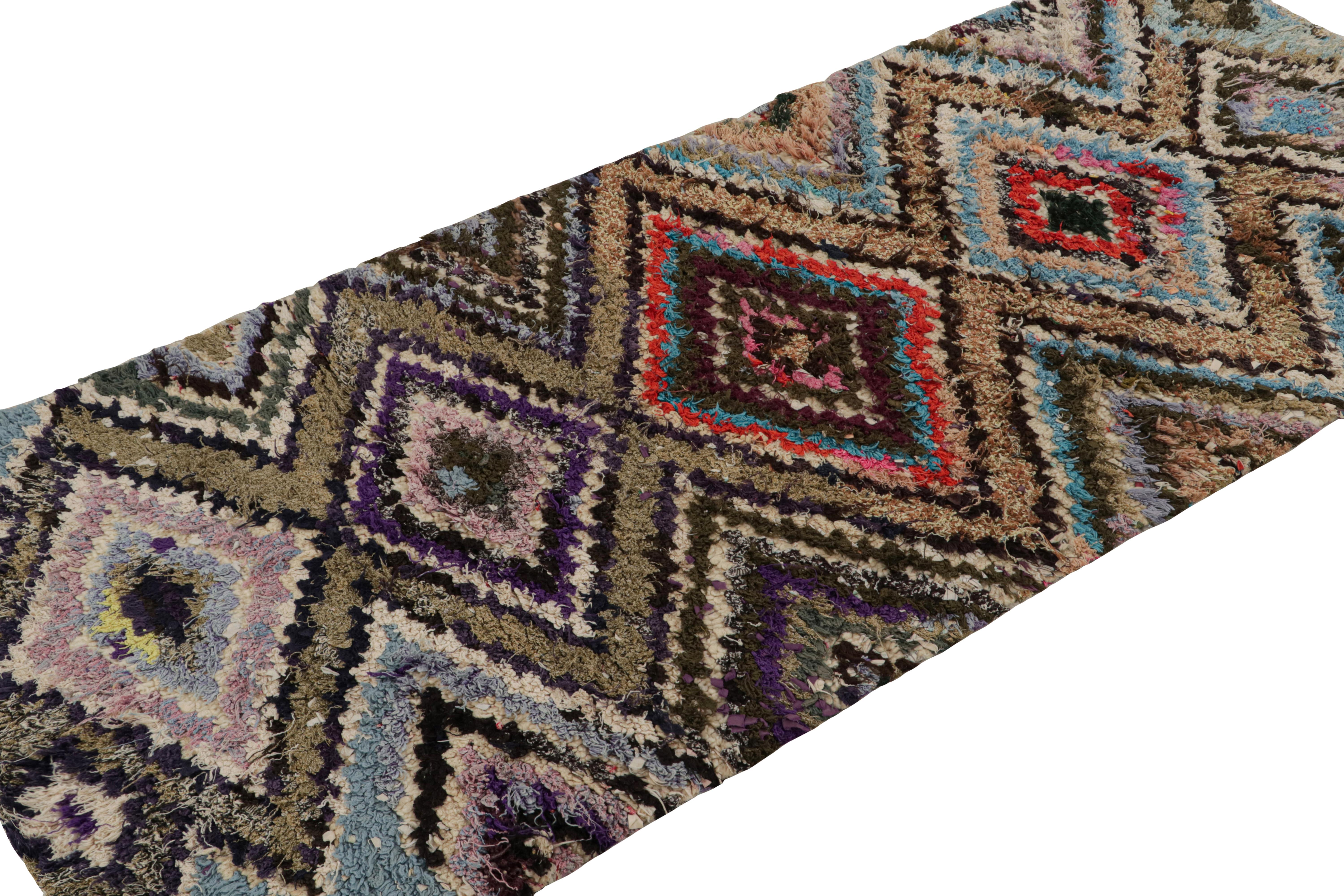 Hand-knotted in wool, circa 1950-1960, this 3x6 vintage Moroccan runner rug is believed to hail from the Azilal tribe. 

On the Design: 

This piece enjoys a lush high pile with polychromatic primitivist Berber geometric diamond medallion or