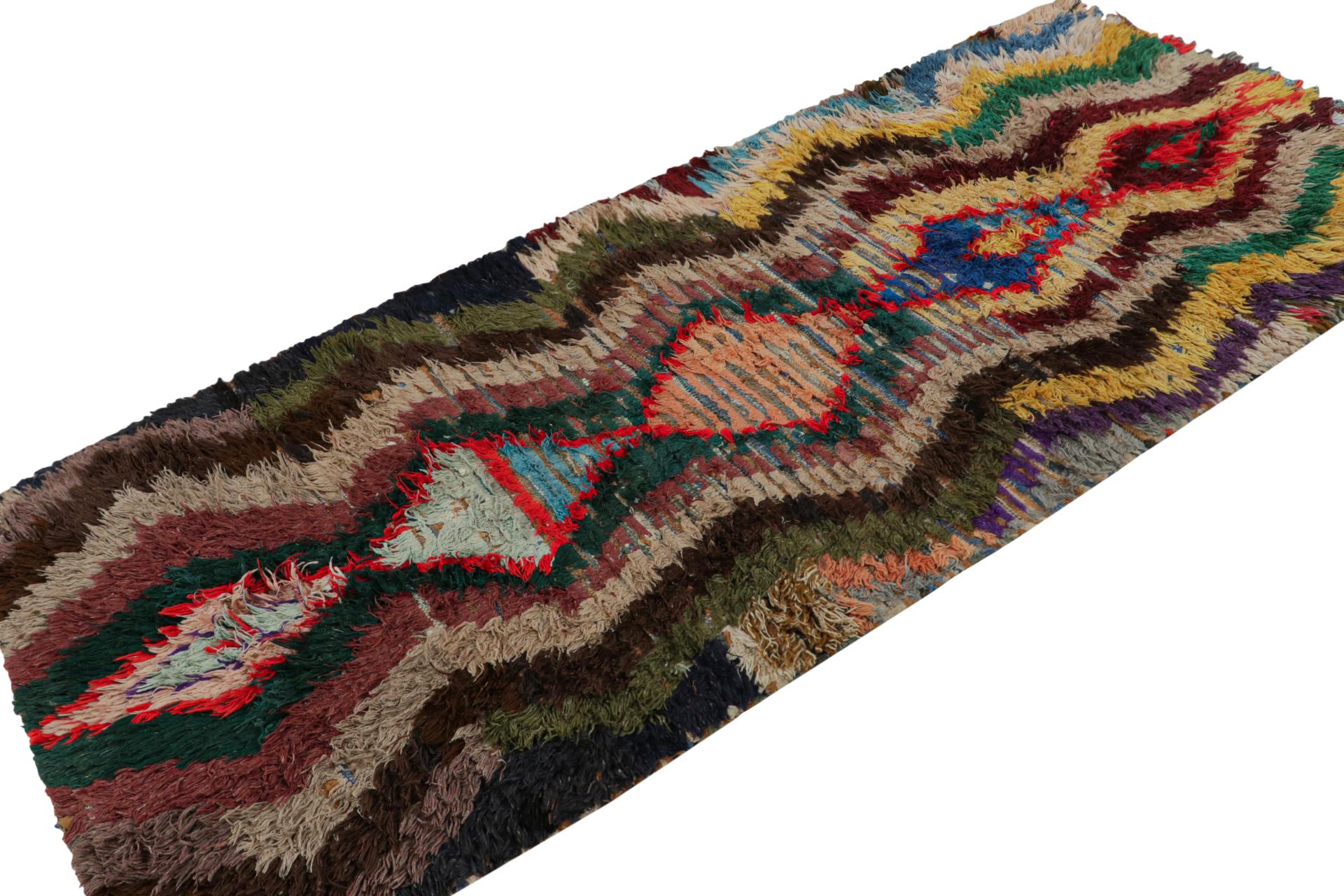 Hand-knotted in wool, circa 1950-1960, this 3x8 vintage Moroccan runner rug is believed to hail from the Azilal tribe. 

On the Design: 

This piece enjoys a lush high pile with polychromatic primitivist Berber geometric diamond patterns and