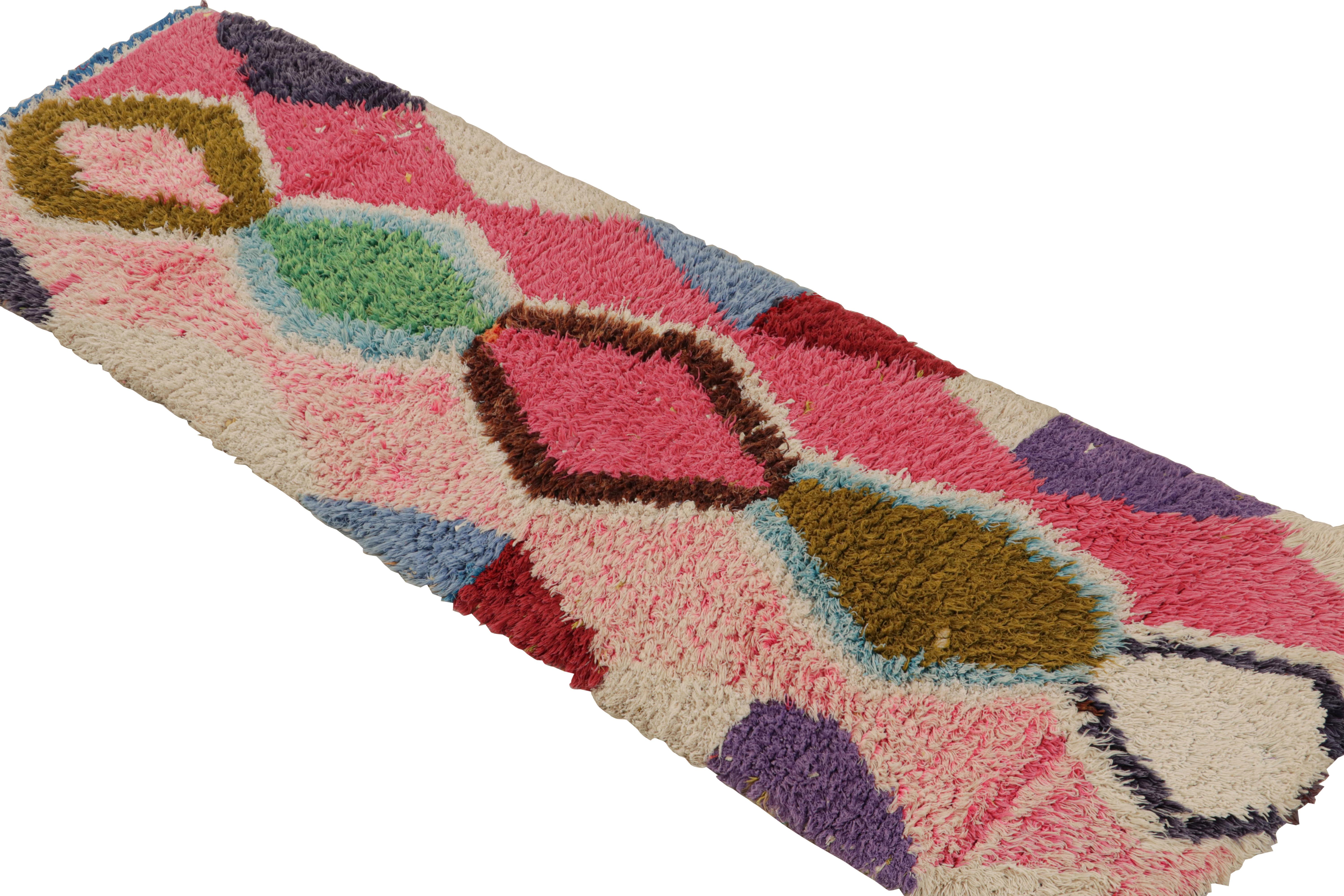 Hand-knotted in wool and cotton, circa 1950-1960, this 2x6 vintage Moroccan runner rug is believed to hail from the Azilal tribe. 

On the Design: 

This piece enjoys a lush high pile with polychromatic primitivist Berber geometric lozenges