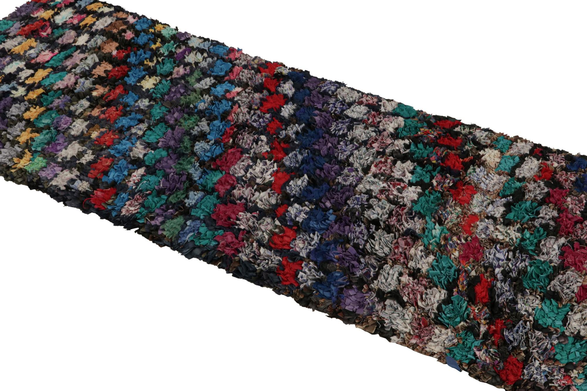 Hand-knotted in cotton and fabric in the titular technique, this vintage 3x7 Moroccan Boucherouite runner is believed to hail from the Azilal tribe. 

On the Design: 

This 1950s runner enjoys an interesting play of red, blue, green and grey tones