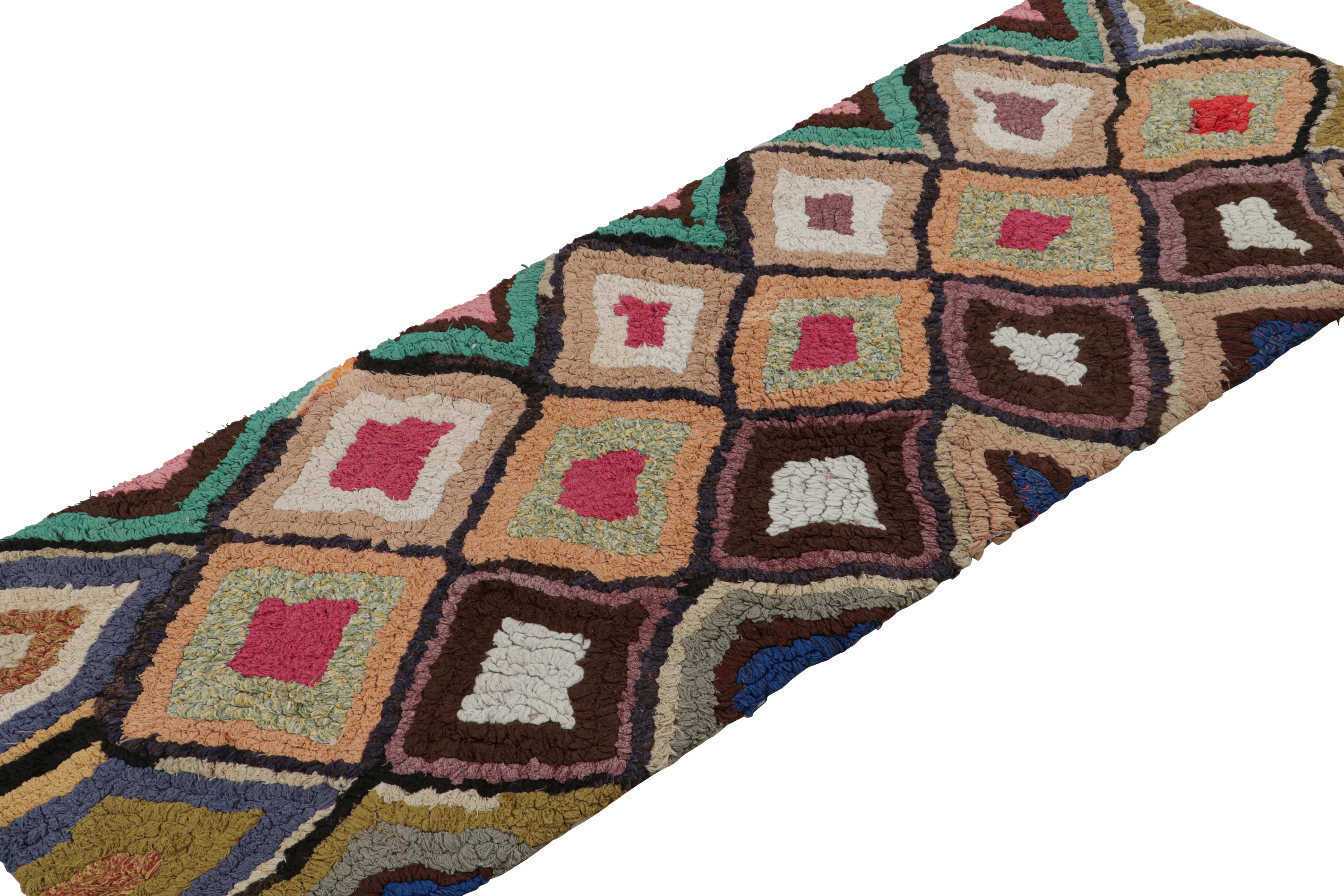 Hand-knotted in wool and cotton, circa 1950-1960, this 2x6 vintage Moroccan runner rug is believed to hail from the Azilal tribe. 

On the Design: 

This piece enjoys a lush high pile with polychromatic primitivist Berber geometric diamond or