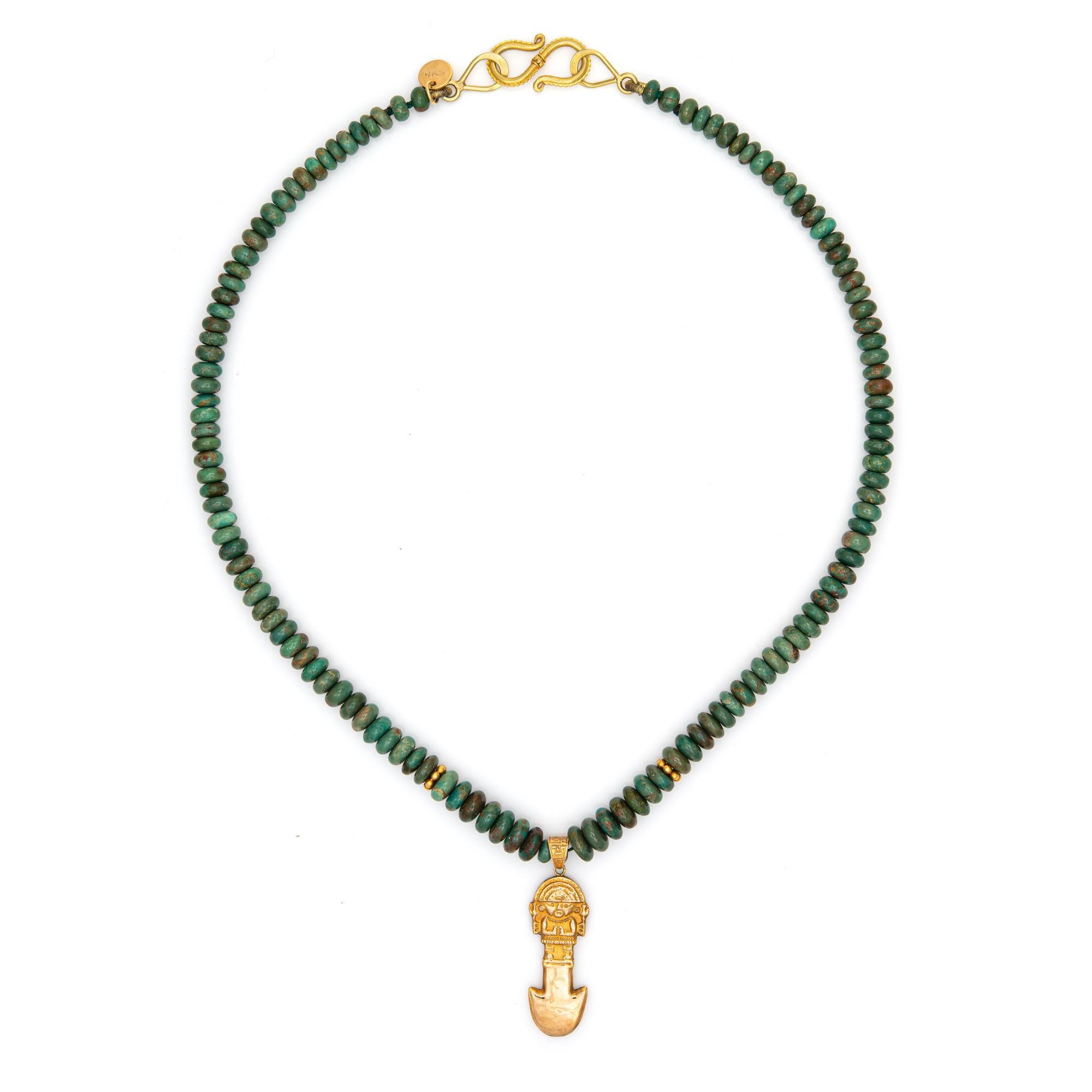 Stylish and finely detailed vintage Aztec necklace crafted in 18 karat yellow gold. 

The necklace features turquoise beads strung onto an 18 1/2 inch strand. The Aztec pendant drop features a double sided design. 18k gold rondels along with an 'S'