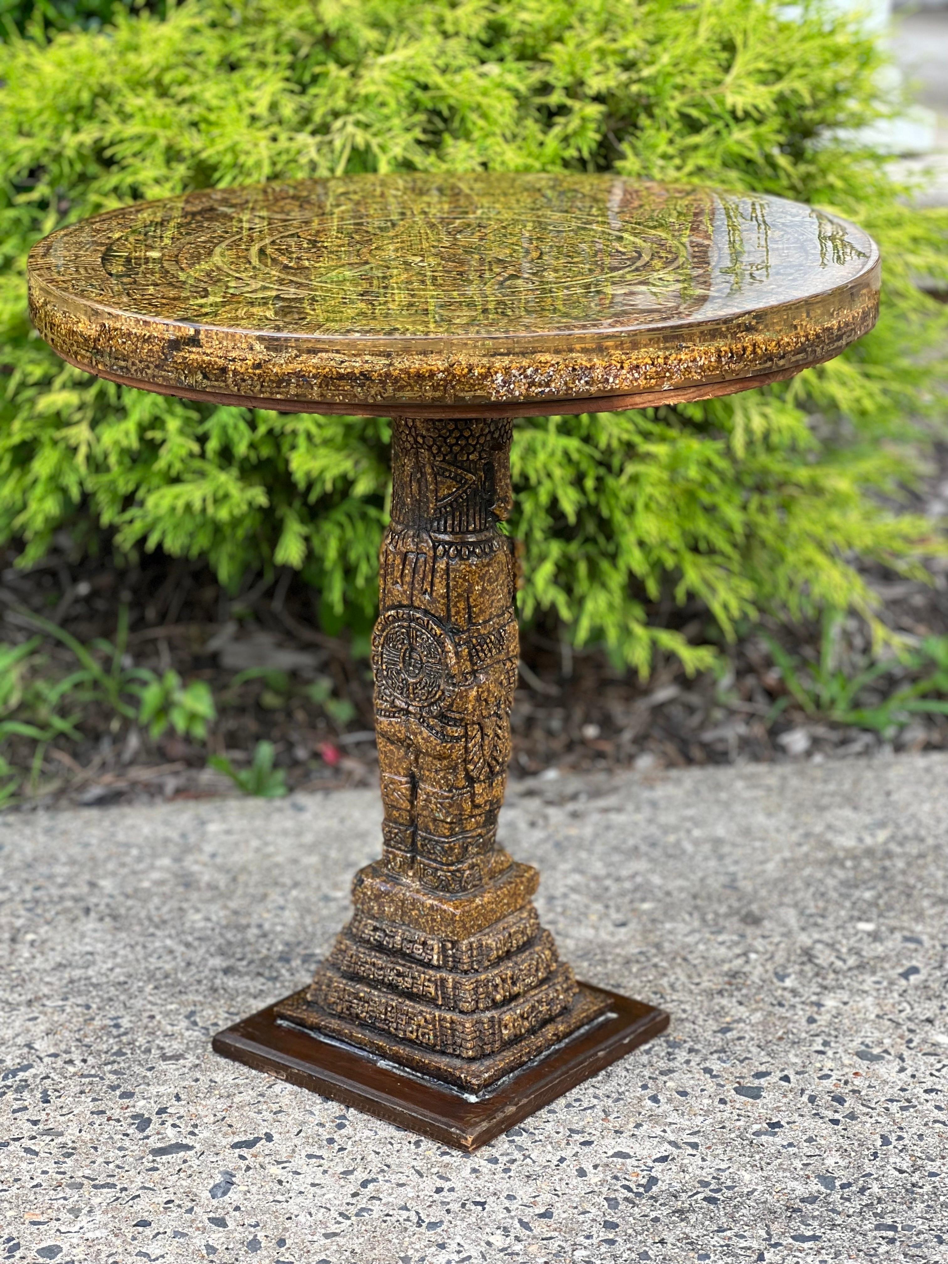 Vintage hand carved Aztec Sun Calendar table, circa 1970's. Made in Mexico.

This pedestal table is intricately carved from Mexican soapstone on a square wood base.  The tabletop is encased in thick lucite, so it is protected and has a smooth