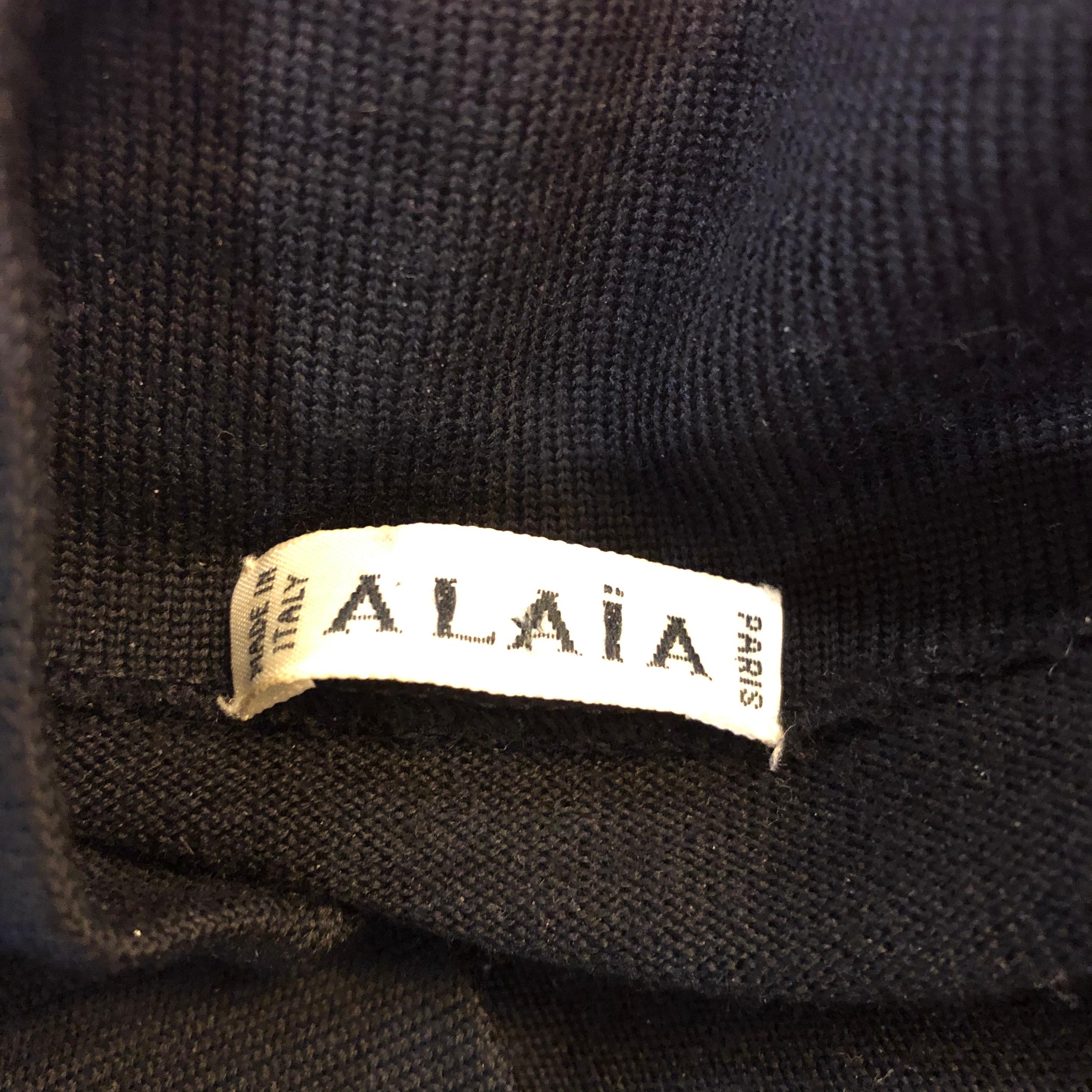 Rare Avant Garde form fitting 1980s AZZEDINE ALAIA black lightweight wool cap sleeve bodcon dress! Features the finest lightweight virgin wool that offers plenty of stretch to fit. Hidden zipper up the side. Super flattering fit with an impeccable
