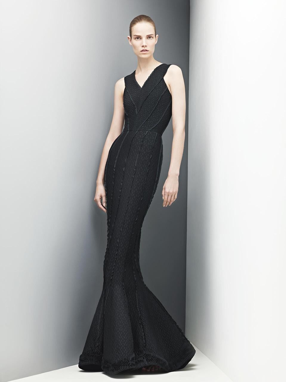 An ultra seductive and instantly recognizable Azzedine Alaia black cutwork patterned metallic accented stretch knit floor-length gown dating back to his 2012 fall-winter collection. Alaïa introduced the world to the 'body' with his ultra flattering