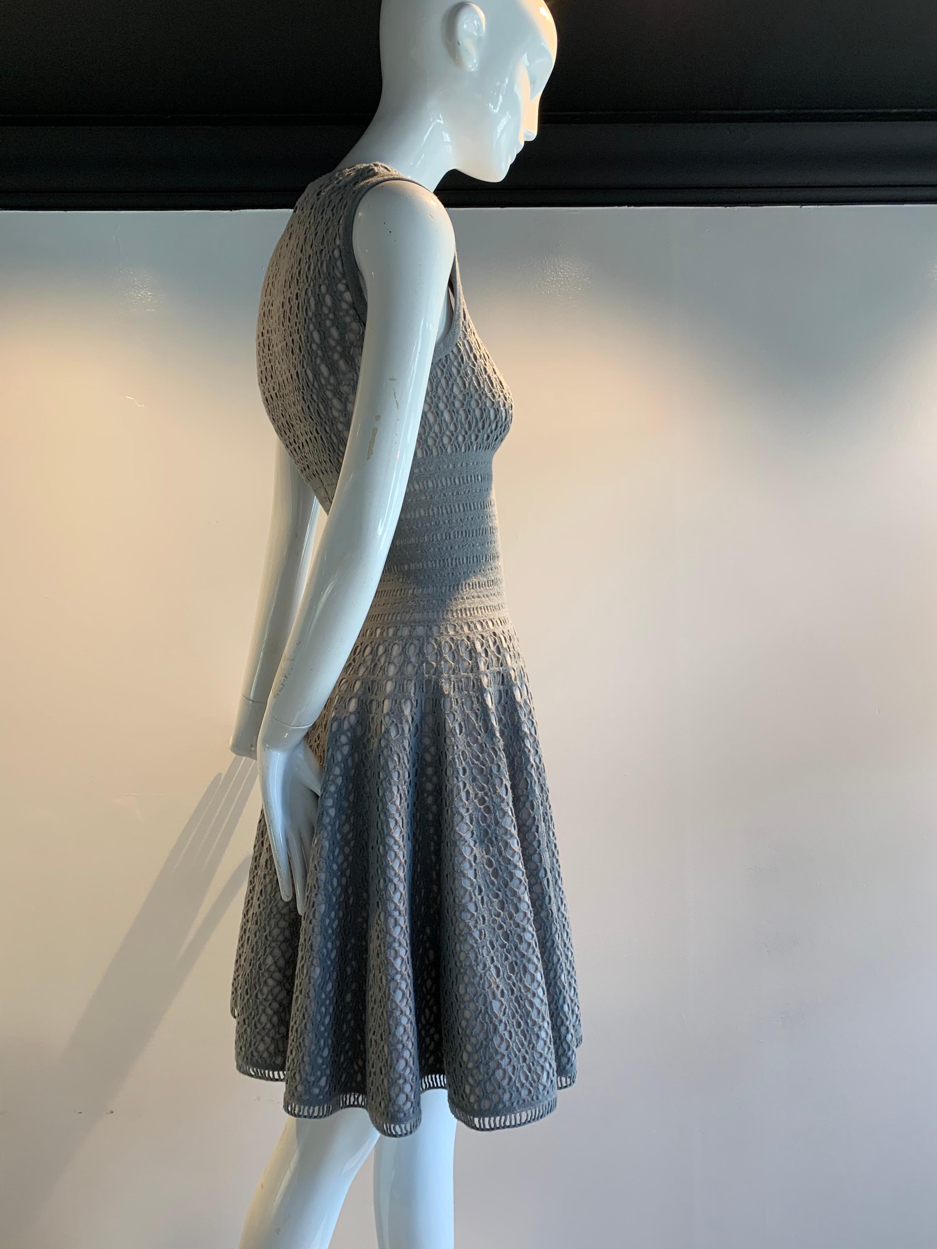 Vintage Azzedine Alaia Dove Grey Signature Elastic Open-Knit Wool-Blend Day Dress. Bodice is fitted and cost-conscious, with a squared neckline. Skirt is full and flared. No closures. Pull over style. Fully lined. French size 38.