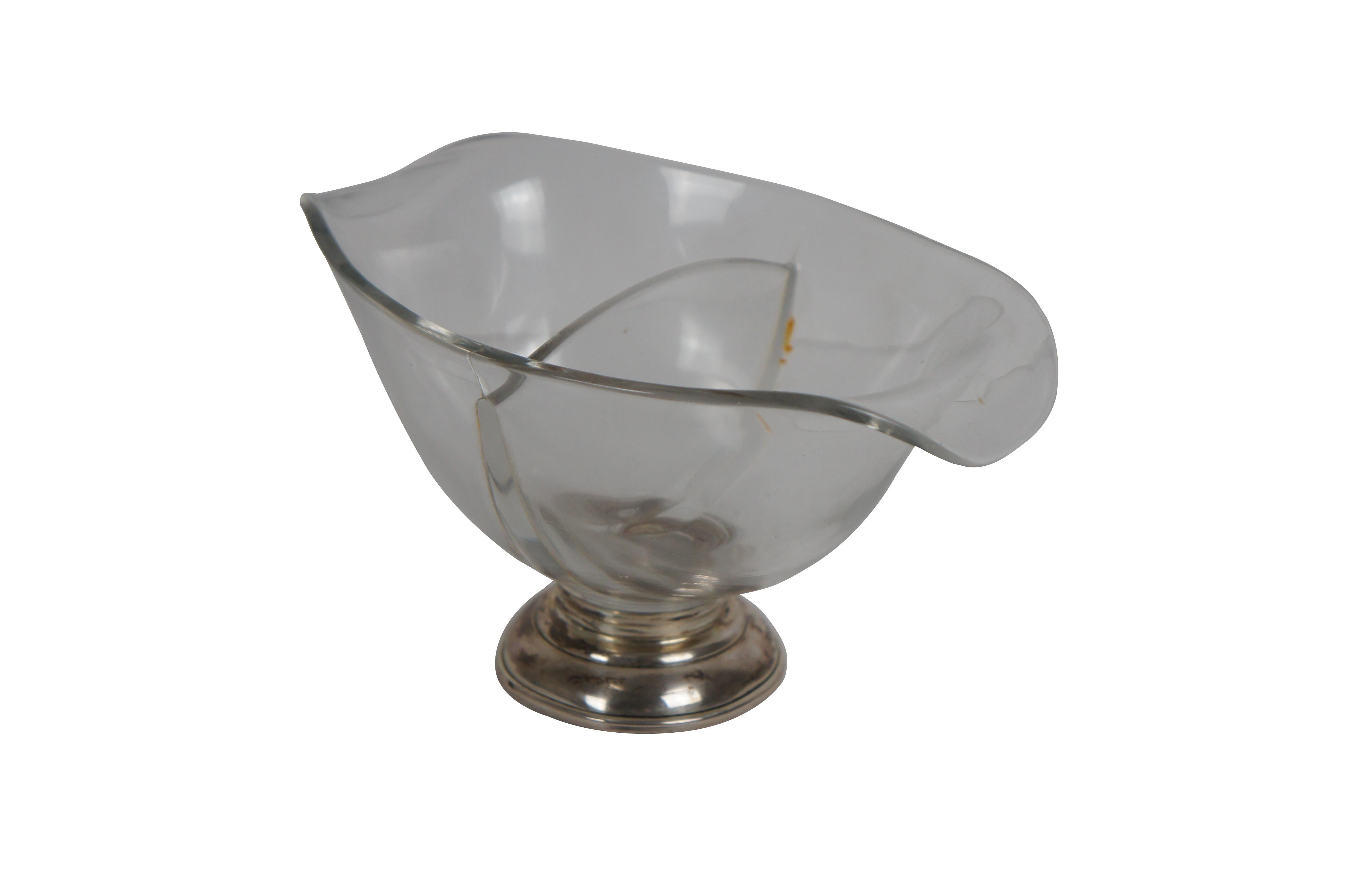 Vintage plain glass candy / nut dish featuring a boat shape with sloping lips at either end, divided into two sections, with a sterling silver pedestal base. Marked B-I Sterling.

Dimensions:
7.5