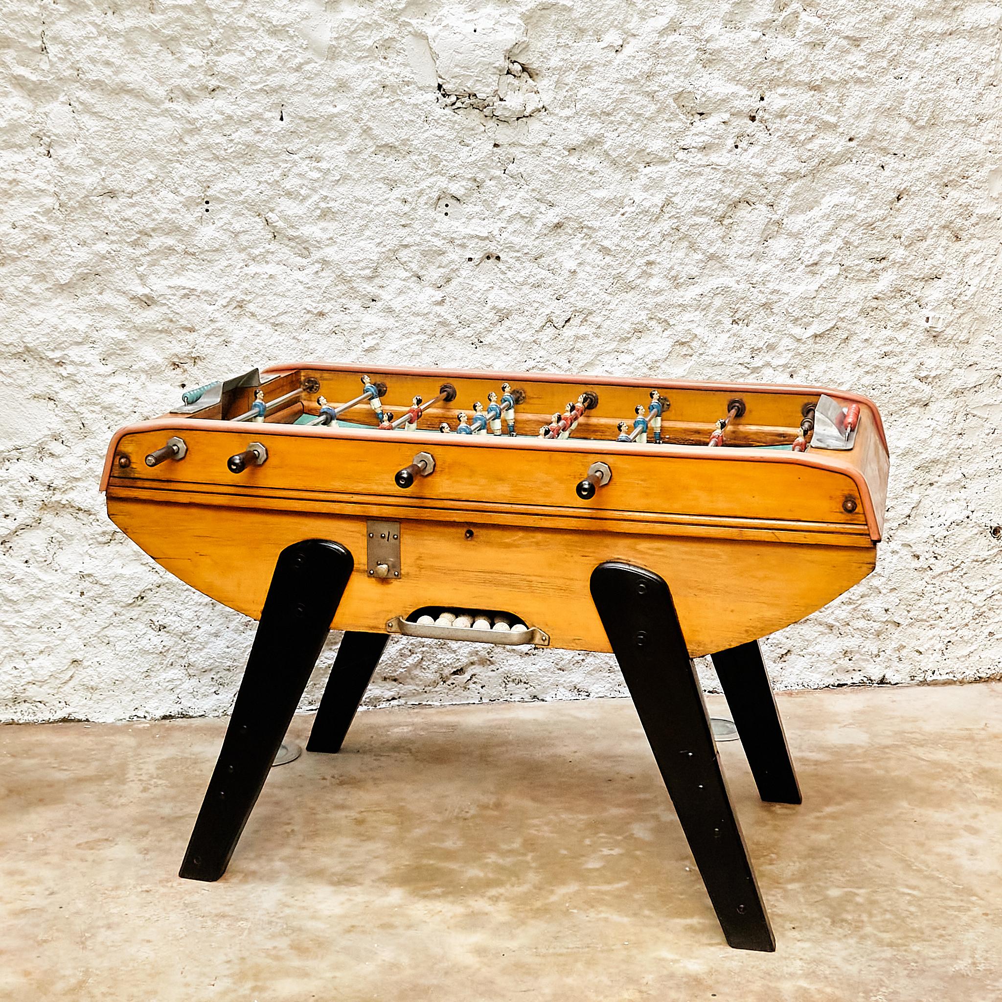 Step back in time to enjoy the vintage charm of this Bonzini Baby Foot Table Football, a cherished Italian classic from the 1960s with the serial number 13144. This exceptional piece retains all its original components, delivering an authentic