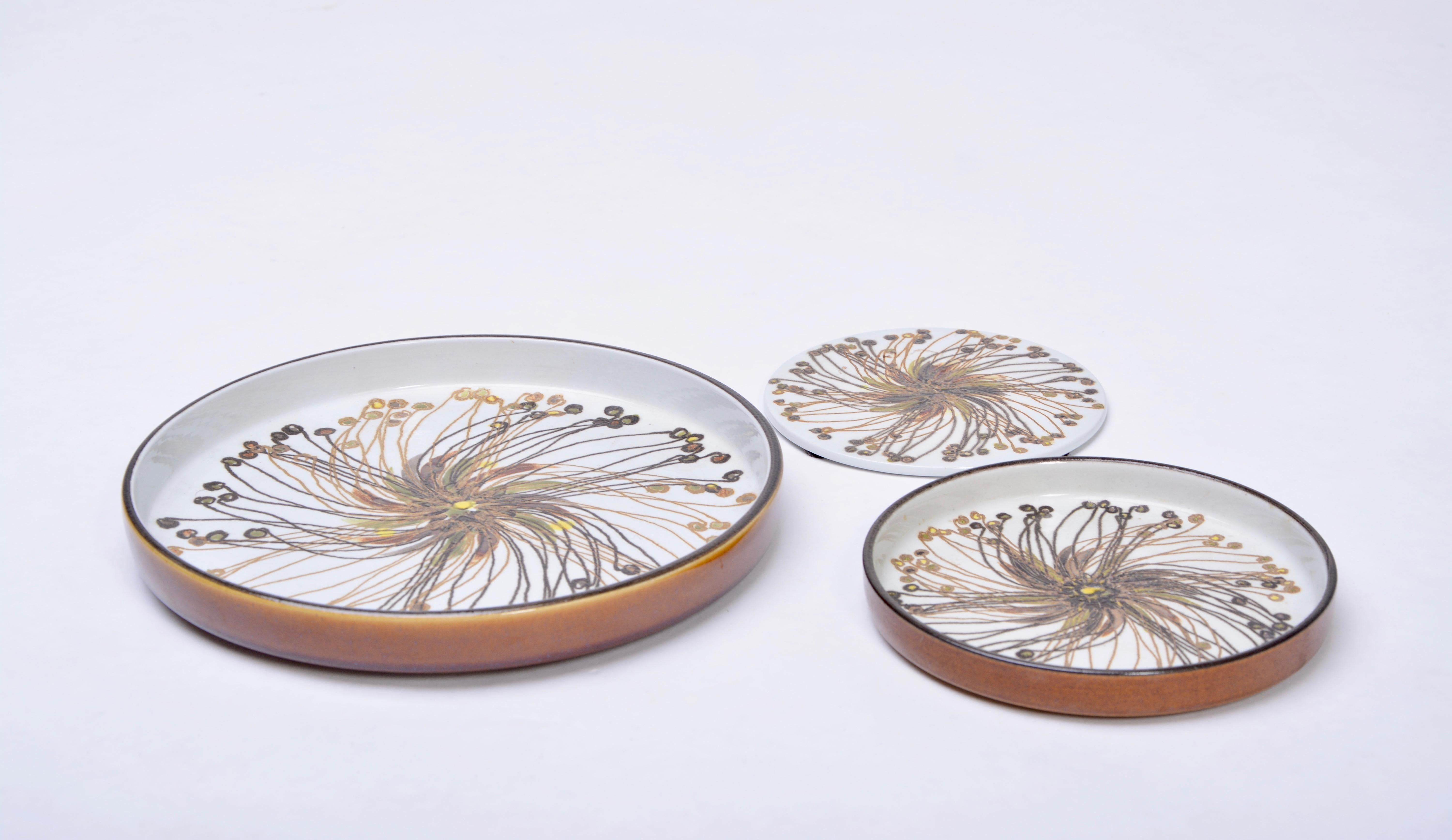 Set of 3 Mid-Century Modern BACA Fajence plates by Ellen Malmer for Royal Copenhagen

This set of three flower plates crafted by the artist Ellen Malmer for Royal Copenhagen. They feature a brown/yellow flower pattern with a white background. Ellen
