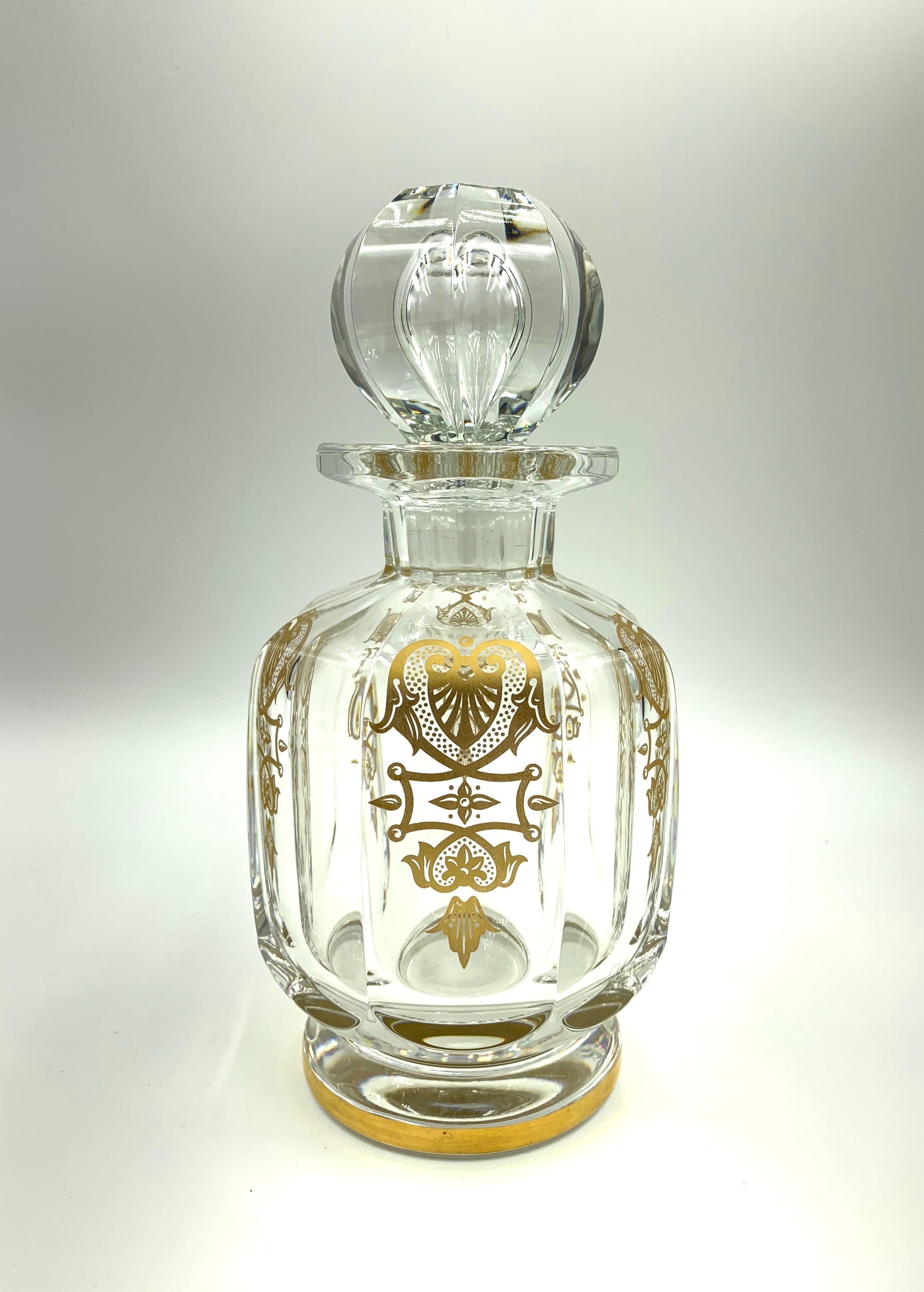 Rare three piece Baccarat crystal Empire vanity set composed of a large scent bottle with stopper, a perfume automizer and a covered jar. Out of production for many years and the epitome of luxury for a dressing room. This set is in very good