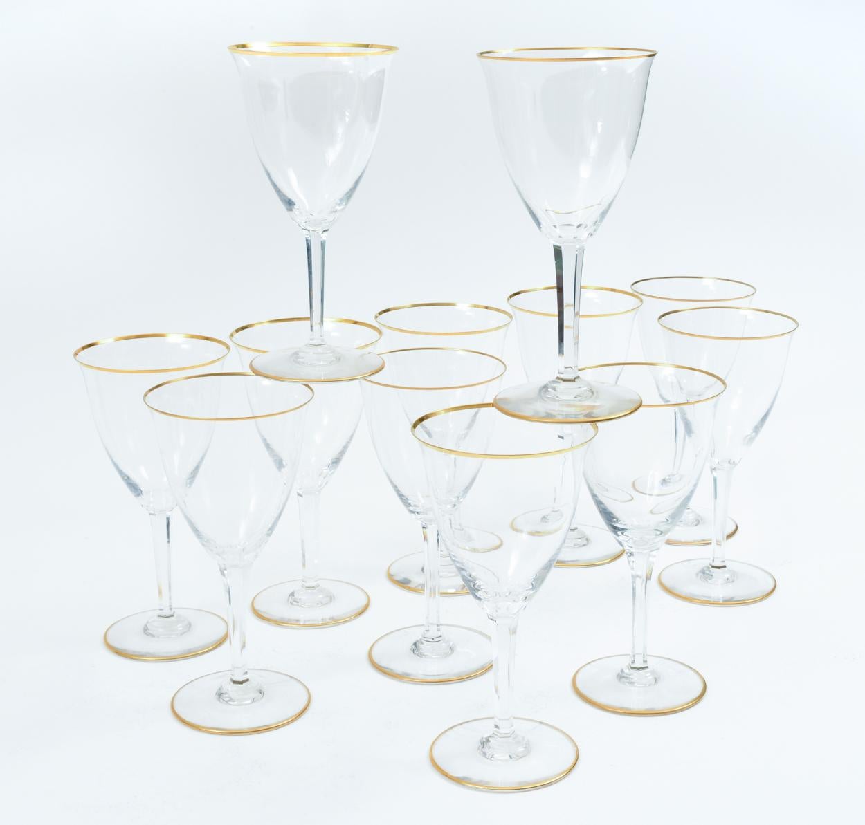 Vintage Baccarat crystal barware / tableware set of 12 wine / water glasses with gold trimmed top and base. Maker's mark undersigned on each glass. Excellent vintage condition. Each glass measure 7.5 inches tall x 4 inches diameter.