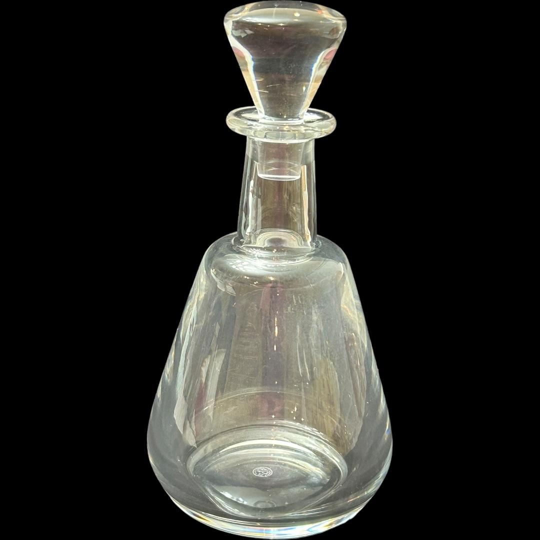 This vintage Baccarat crystal liquor decanter is a stunning piece that will add a touch of elegance to any bar ware collection.  Crafted in France, this “perfection” pattern clear crystal decanter features a sleek design and is perfect for serving