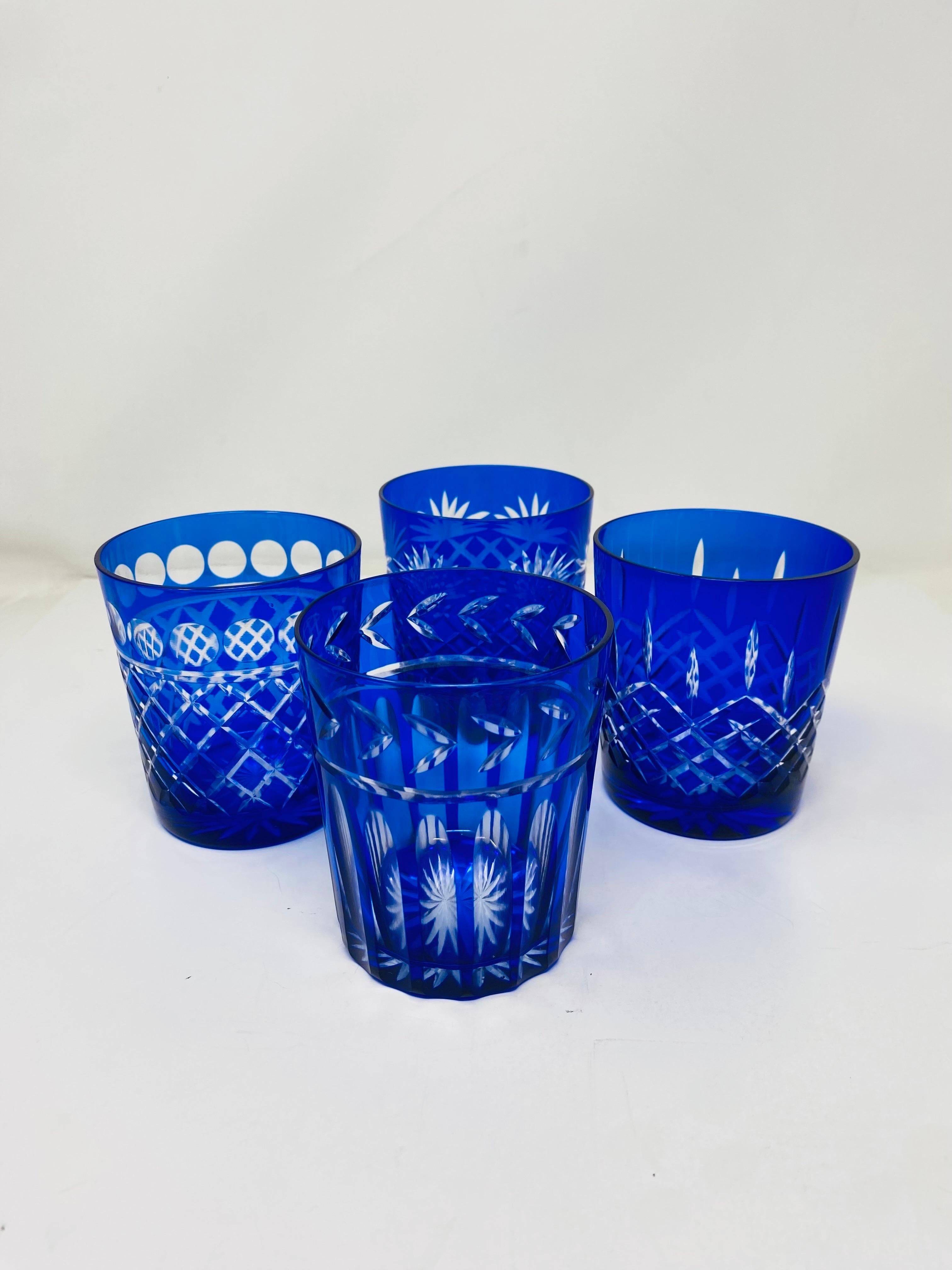 Beautiful set of 4 different Imperial Estate Triumph Cobalt Crystal Cut Glasses.  This set features 4 different designs and a beautiful, deep cobalt blue color.  The incredible cut brings these glasses to showpieces.  Intricate but with constrained