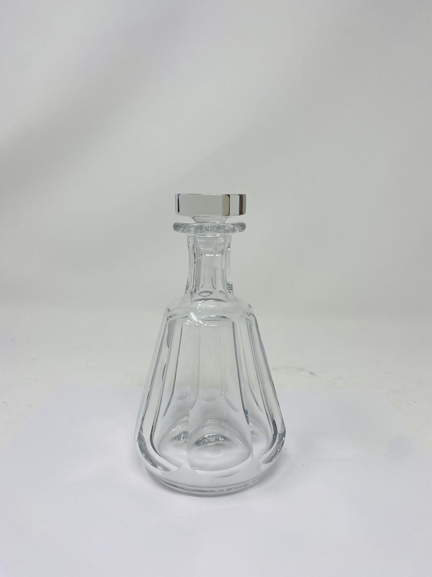 Beautiful and sleek decanter by Baccarat.  Created in a smaller scale, this is a beautiful piece that will hold your whiskeys/spirits in great style.  In great condition with a small fleabite in the stopper that is almost unnoticeable.  Stylish and