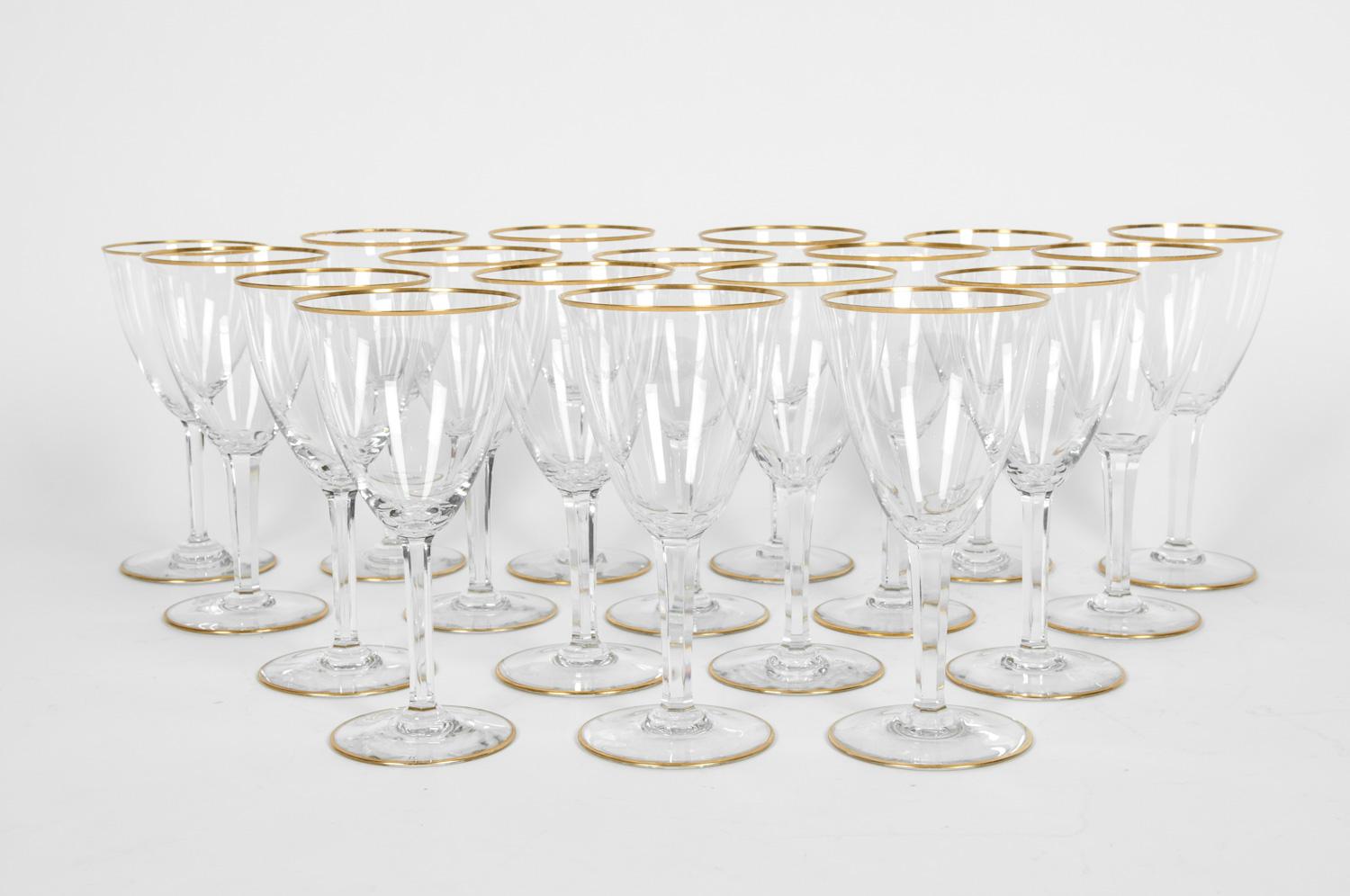 Vintage Baccarat crystal set of 18 wine or water glasses with gold trimmed top and base. Maker's mark undersigned on each glass. Excellent condition. Each glass measure 7 3/8 inches tall x 3 5/8 inches across x 3 1/4 inches base.