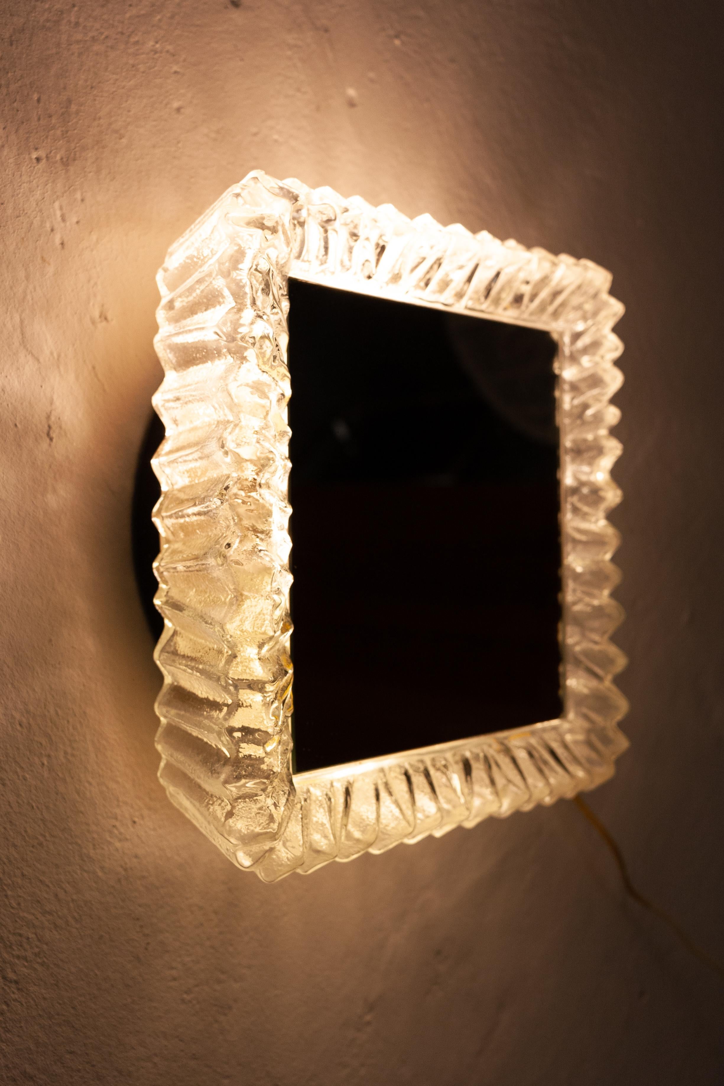 Vintage back light mirror. Frosted glass frame, with a mirror, square shape. Two bulbs inside.
Very nice and useful mirror, early 1960s.




 