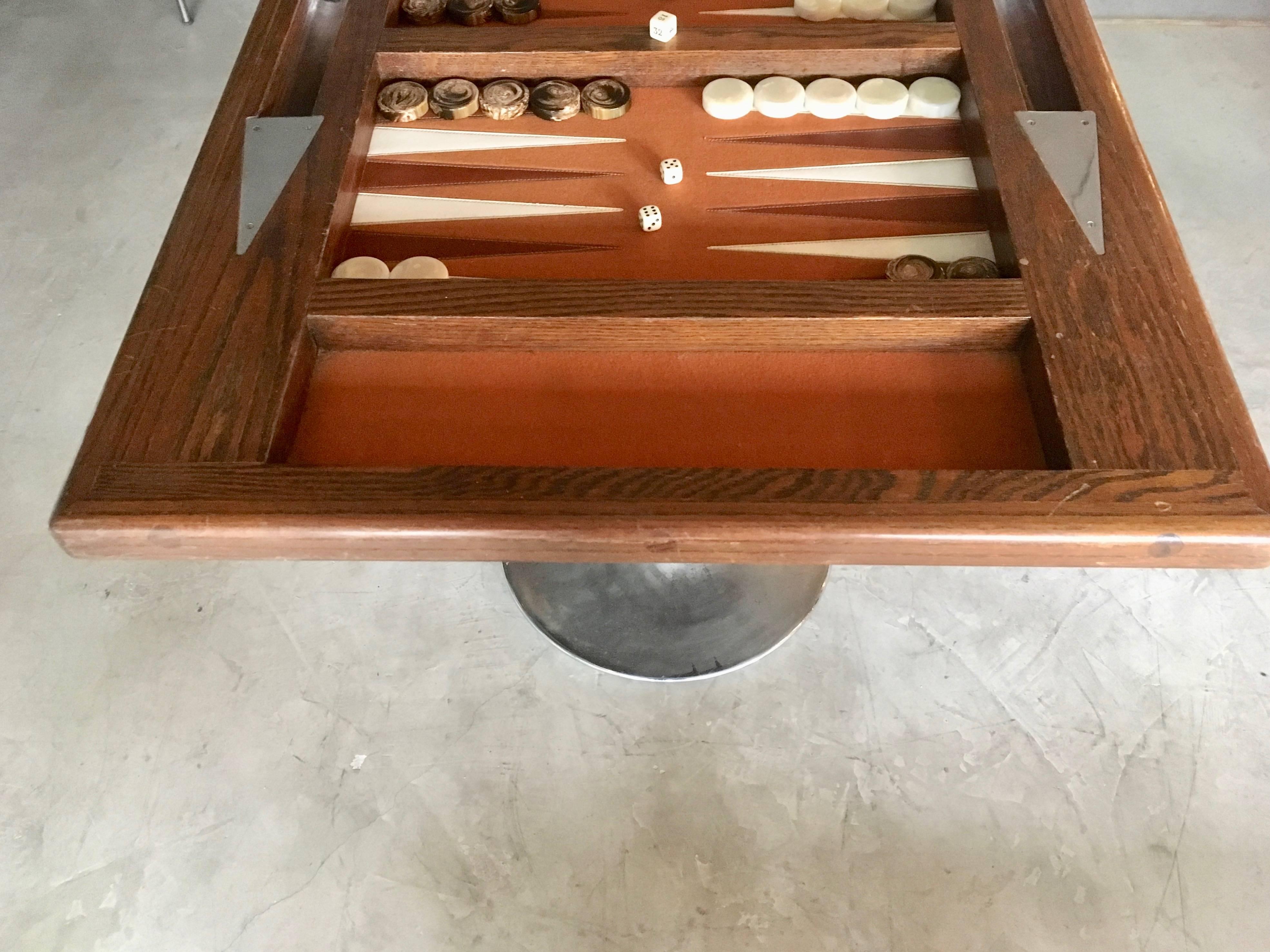 Great vintage wood backgammon table. Felt top with leather triangles. Vintage bakelite backgammon pieces included. Tulip base allows to place any time of chair underneath. Large size tabletop. Good vintage condition.