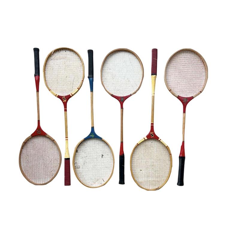 Vintage set of six badminton, tennis, or squash rackets in red white, and blue. Each racket is made from wood and in wonderful vintage condition. This set would make a great focal point hung on a wall for the sports lover. Or perhaps for using them