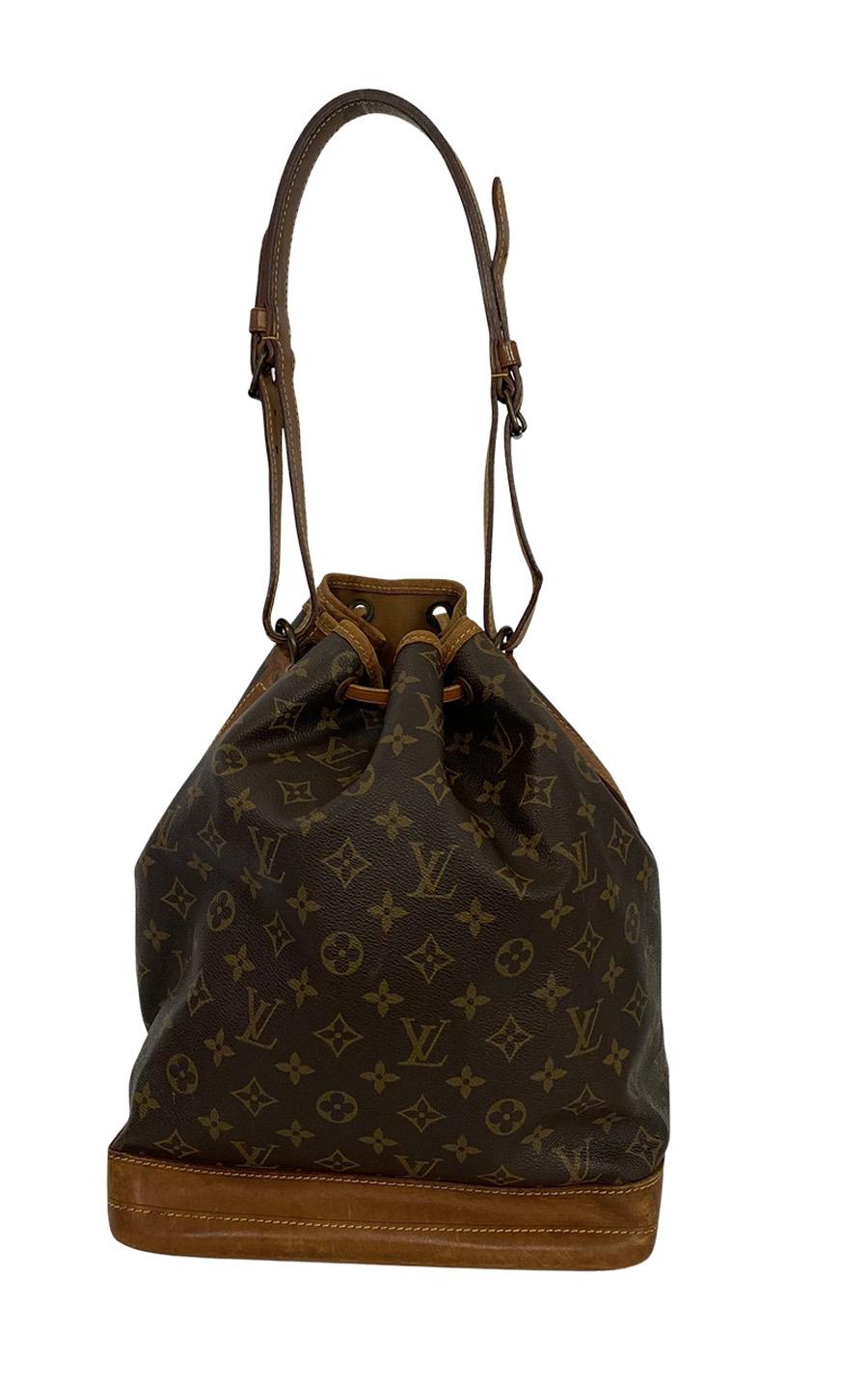 Louis Vuitton Noé made of Monogram Canvas and Vachetta leather. The bag closes with a drawstring and features an adjustable leather shoulder strap. The bag can be worn on the shoulder, unfortunately, the strap is too short to be worn as a crossbody