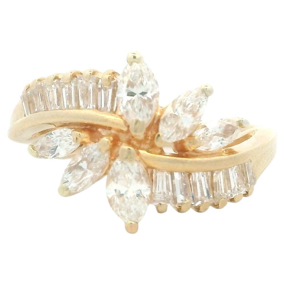 This vintage 14-karat yellow gold cluster ring showcases a striking arrangement of twelve baguette-cut diamonds and six marquise-cut diamonds, totaling approximately 1.62 carats. The diamonds, graded G-H in color and SI1 in clarity, are set in a