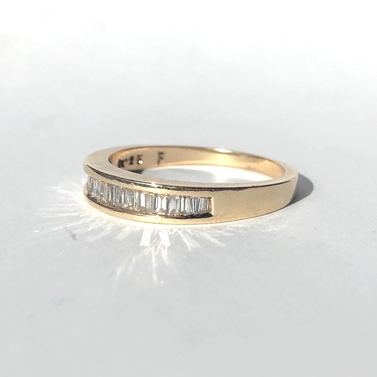 This stunning baguette diamond and 9ct gold band has a gorgeous reflective sparkle. The baguette diamonds are tapered and perfectly slotted together which make the line of diamonds sparkle even more. The diamonds range from 4pts to 8pts. Made in
