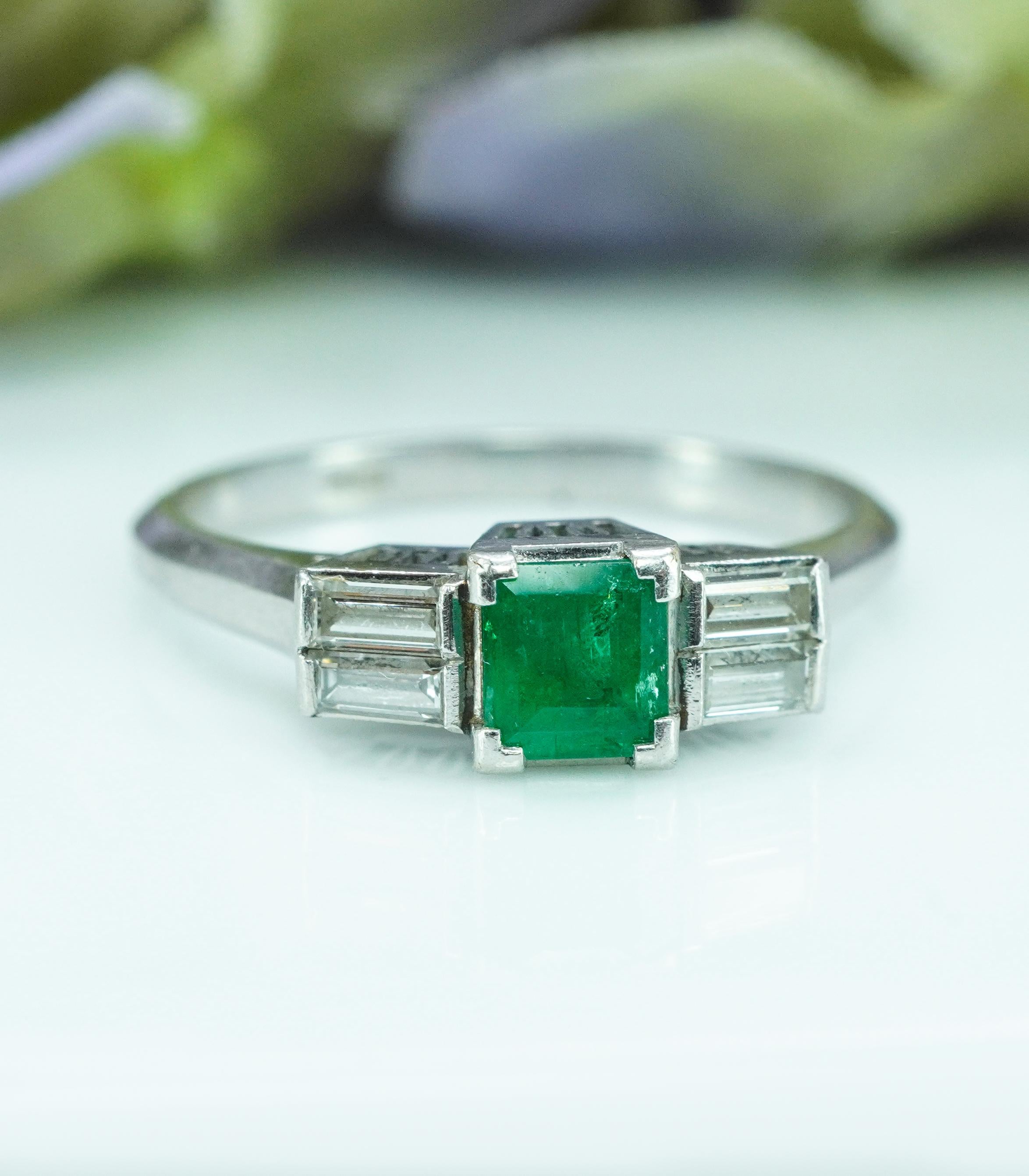  Vintage Baguette Diamond Emerald Platinum Filigree Ring Estate Dainty

This is platinum vintage estate piece. There is a genuine earth mined square cut emerald set in the center, measuring 4.12mm x 4.12mm. It is estimated to be .45 carat. Very