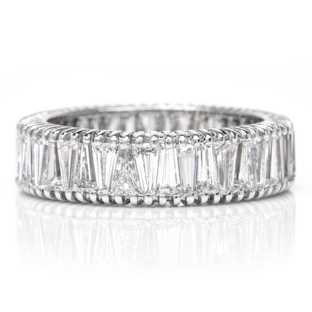 This vintage diamond eternity band ring is crafted in solid platinum. This shimmering ring features approx. 41 genuine tapered baguette shaped diamonds approx. 5.50 carats, H-I color, VS clarity. Measures 2mm height x 5.50 mm wide and weighs 5.5