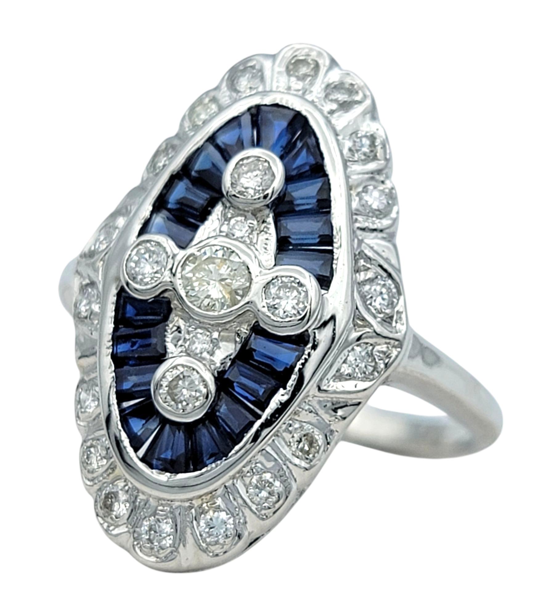 Ring Size: 6.5

Exuding elegance and sophistication, this breathtaking navette style cocktail ring showcases a mesmerizing arrangement of baguette-cut blue sapphires and round-cut diamonds. The elongated silhouette, adorned with intricate detailing,