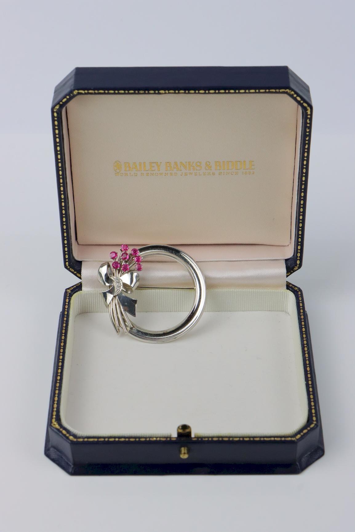 Vintage Bailey Banks & Biddle Ruby Platinum Diamond Brooch 
Marked:
BBB 83229 

Approximate Dimensions:
4.12 cm (Diameter)
15.2 grams in weight