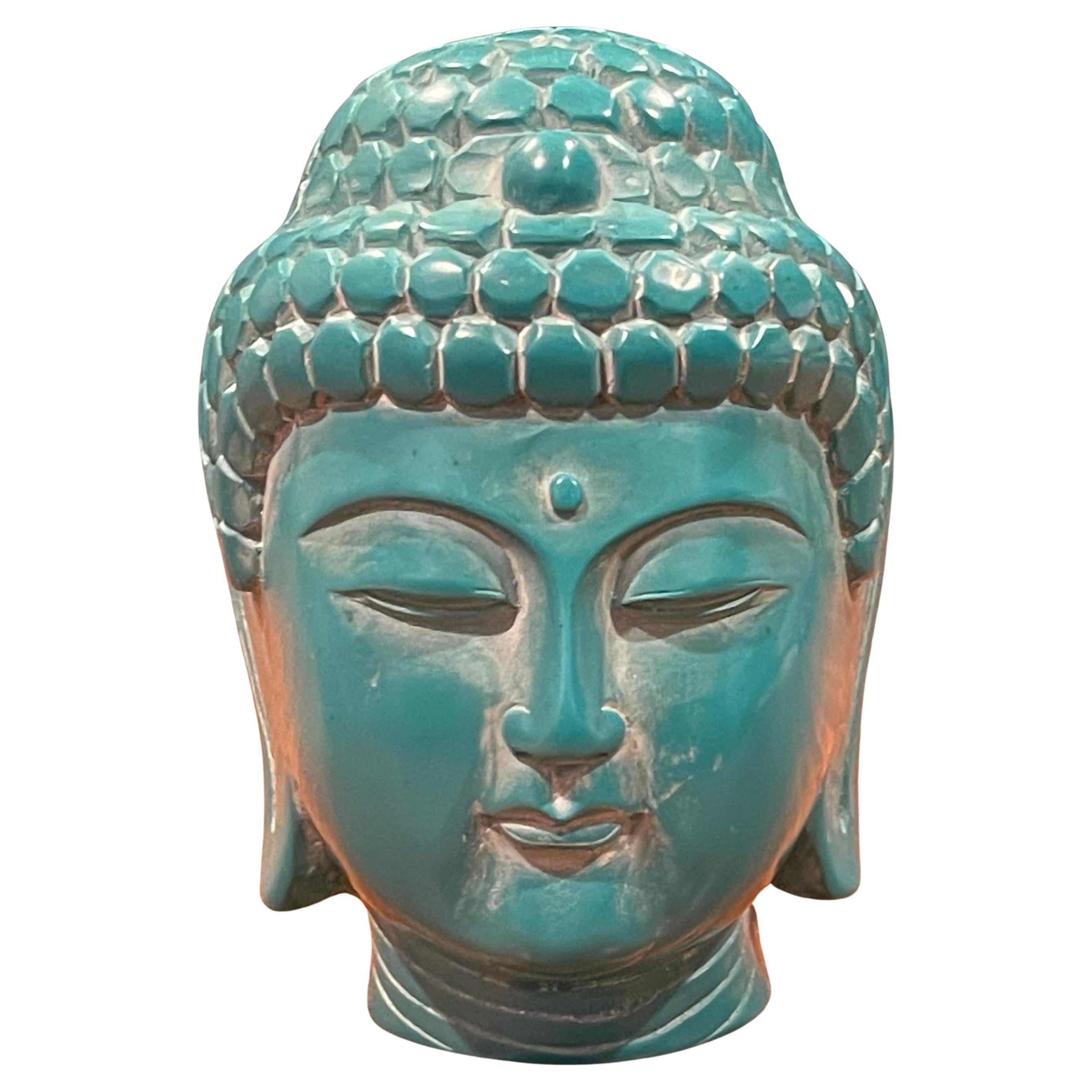 A very cool hand carved vintage Buddha head in teal bakelite on a rosewood stand, circa 1970s. The carved figure is a representation of Gautama Buddha, also known as the enlightened or awakened one. The piece is in very good vintage condition and