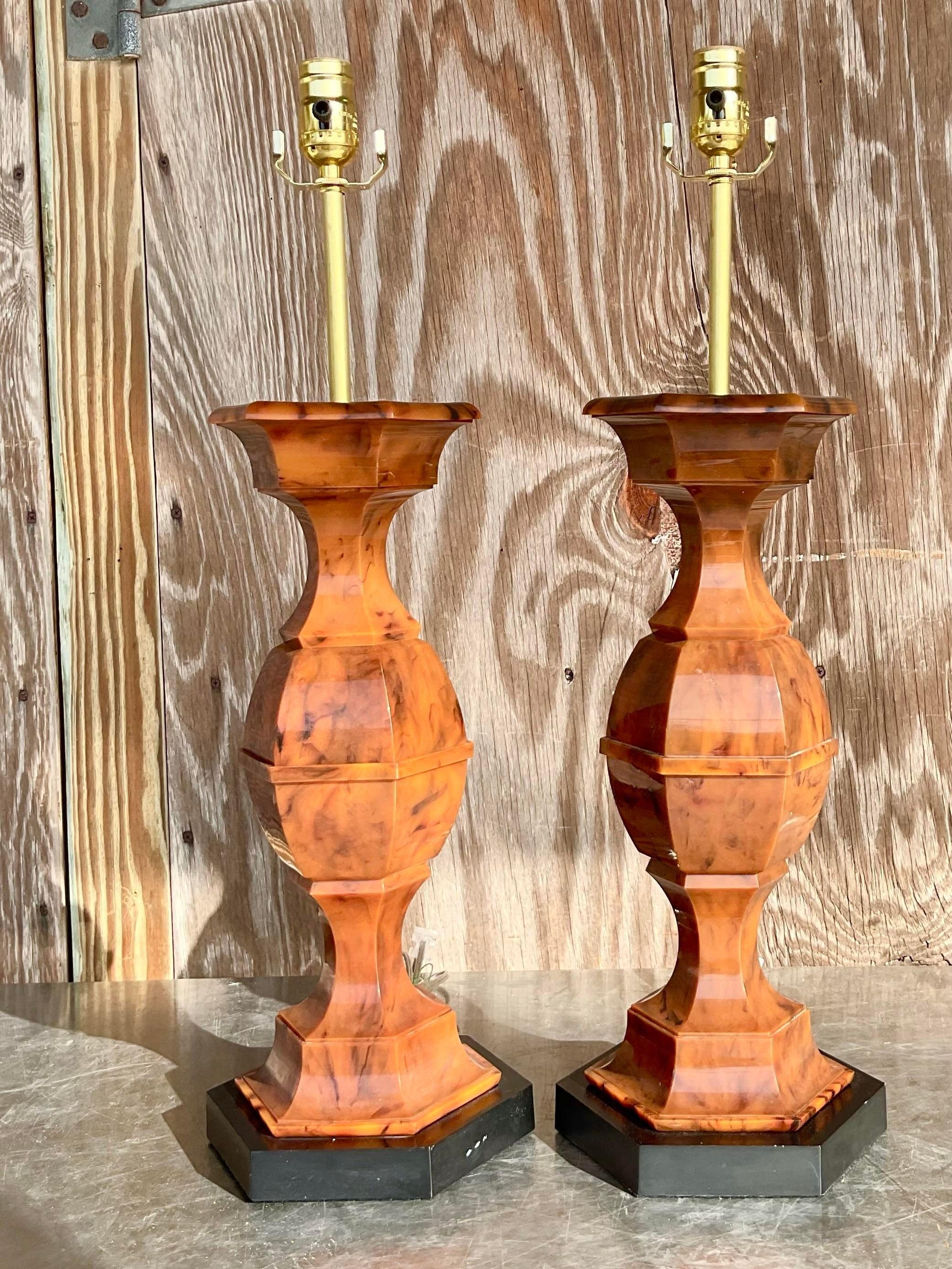 Epic pair of vintage Bakelite stack style hourglass shaped table lamps. Fun period addition to any sideboard or credenza to immediately marry the worlds of old and new. Acquired from a Palm Beach estate