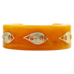 Vintage Bakelit Orange Manschette mit Gold Evil Eye Pieces