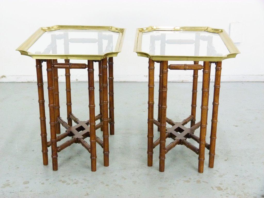 Gorgeous faux bamboo base with brass and glass top Baker style rectangular side tables. Bases are constructed of stained wood, does not collapse with removable brass trimmed glass top trays. Although tray tables, they are very sturdy.