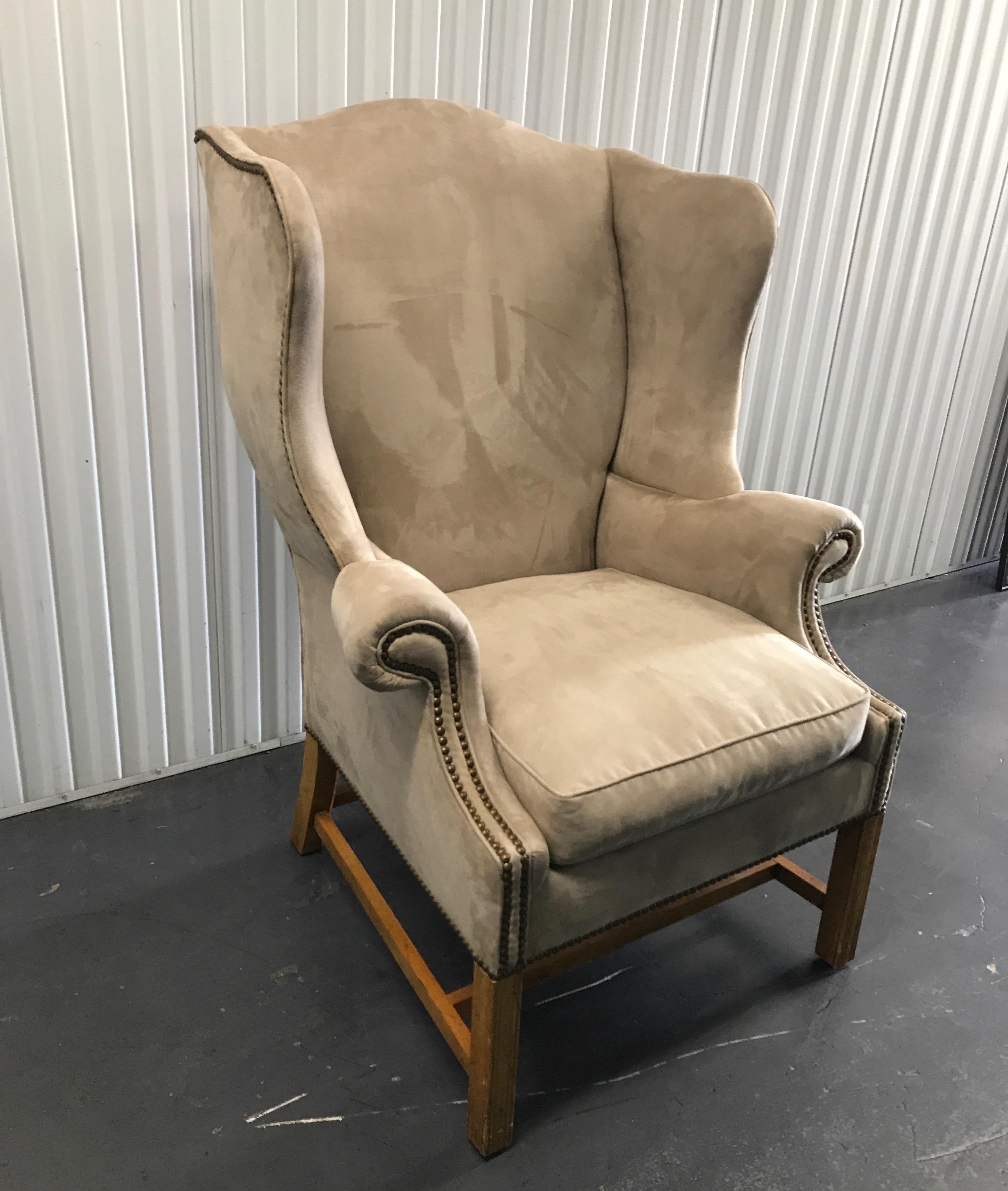 Vintage Baker Furniture Co. Chippendale style wing chair upholstered in a taupe ultra suede fabric with nail heads.