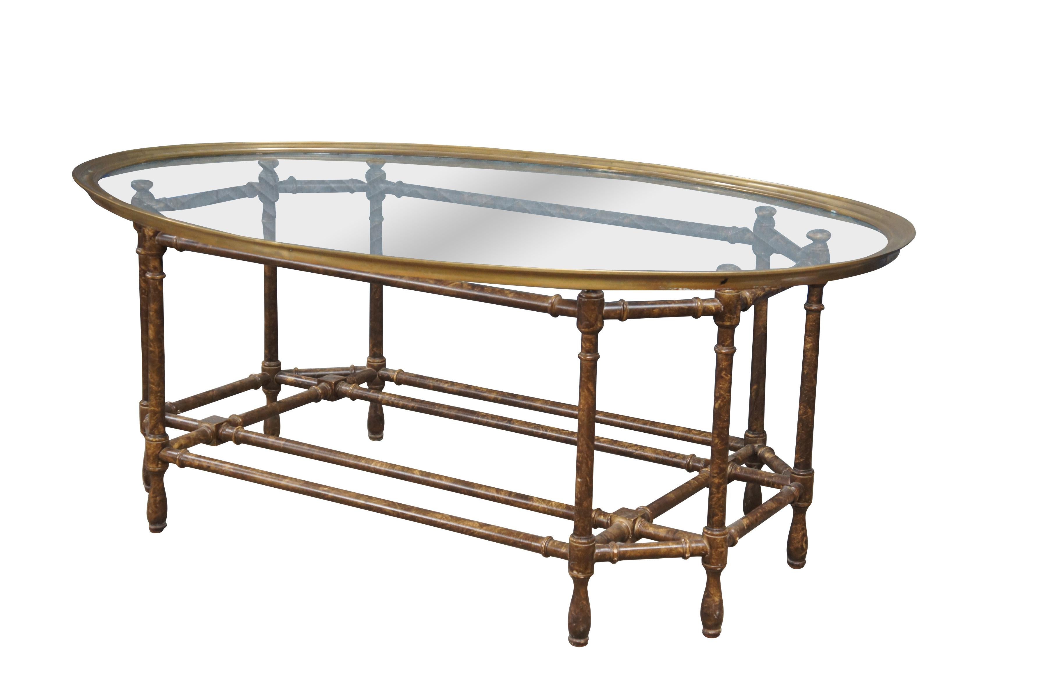 Vintage Baker Furniture faux bamboo tortoise shell finish coffee or cocktail table featuring an oval top with brass gallery edge.  Unmarked.

Dimensions:
31