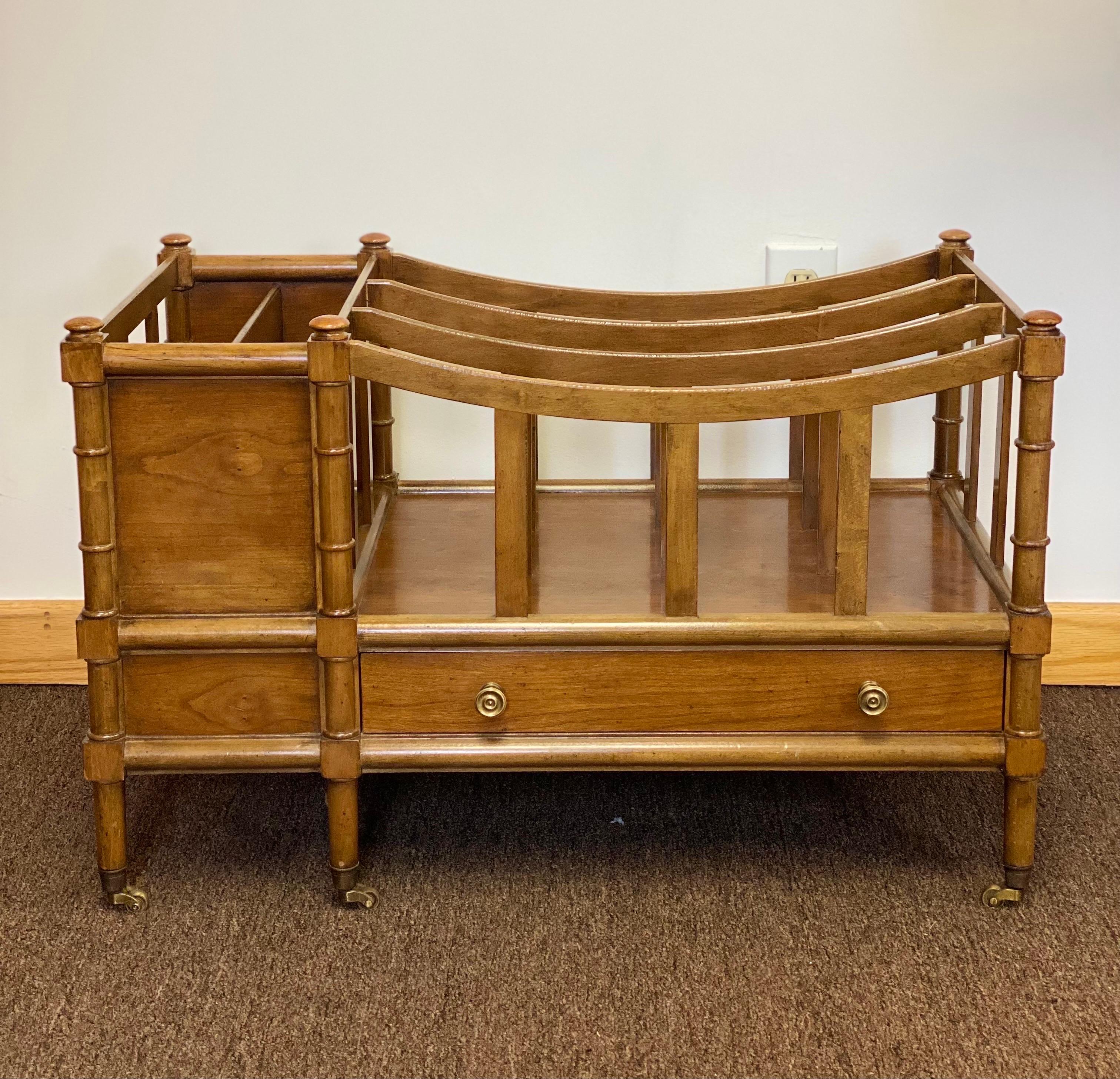 We are very pleased to offer a beautiful music caddy or magazine rack by Baker Furniture Company, circa the 1960s. Finely handcrafted from solid hardwood oak or cherry, this American made piece features magnificent artistry and a beautiful finish.