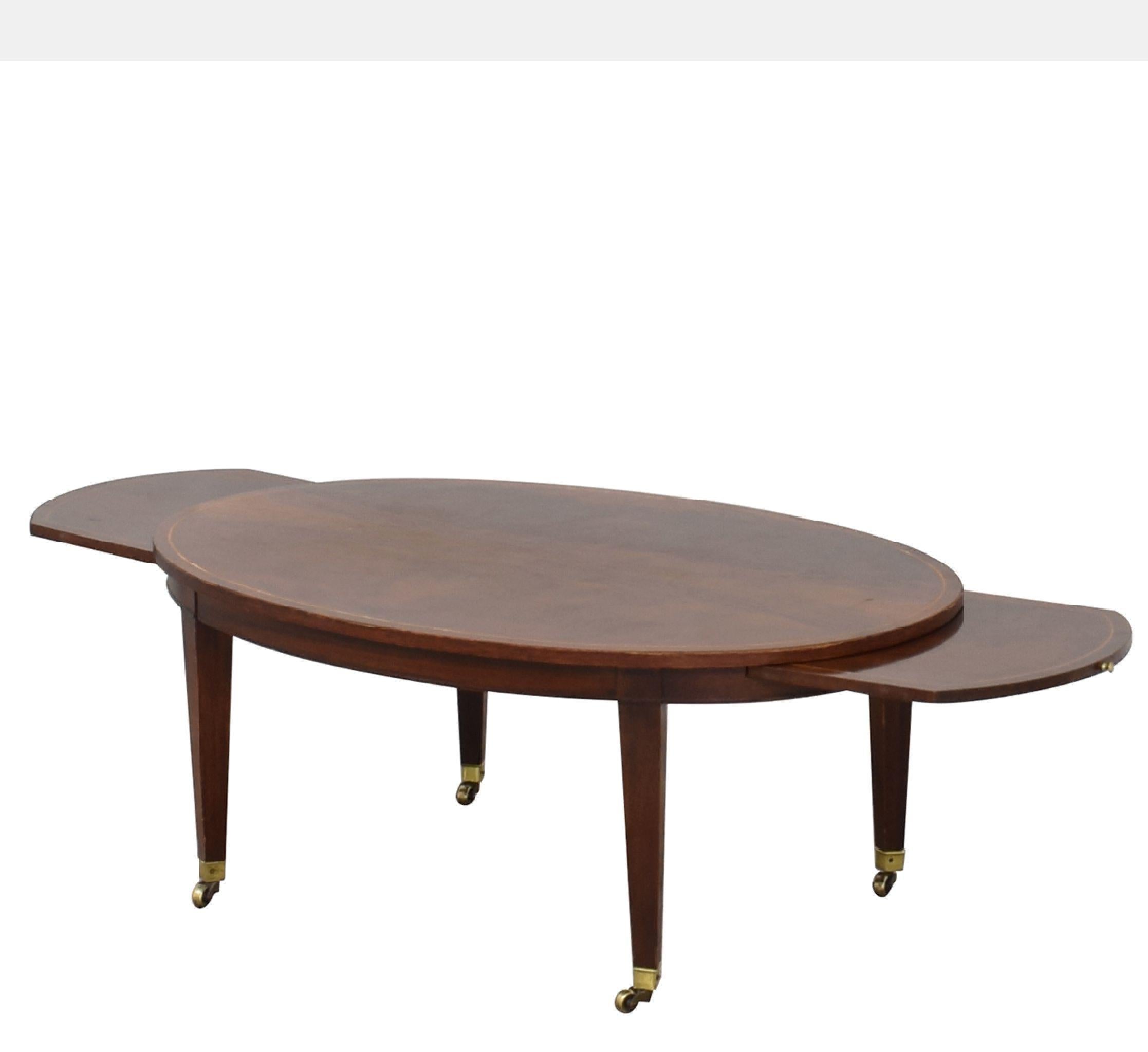 Vintage Baker Furniture extendable oval neoclassical coffee table. Width extends from 42