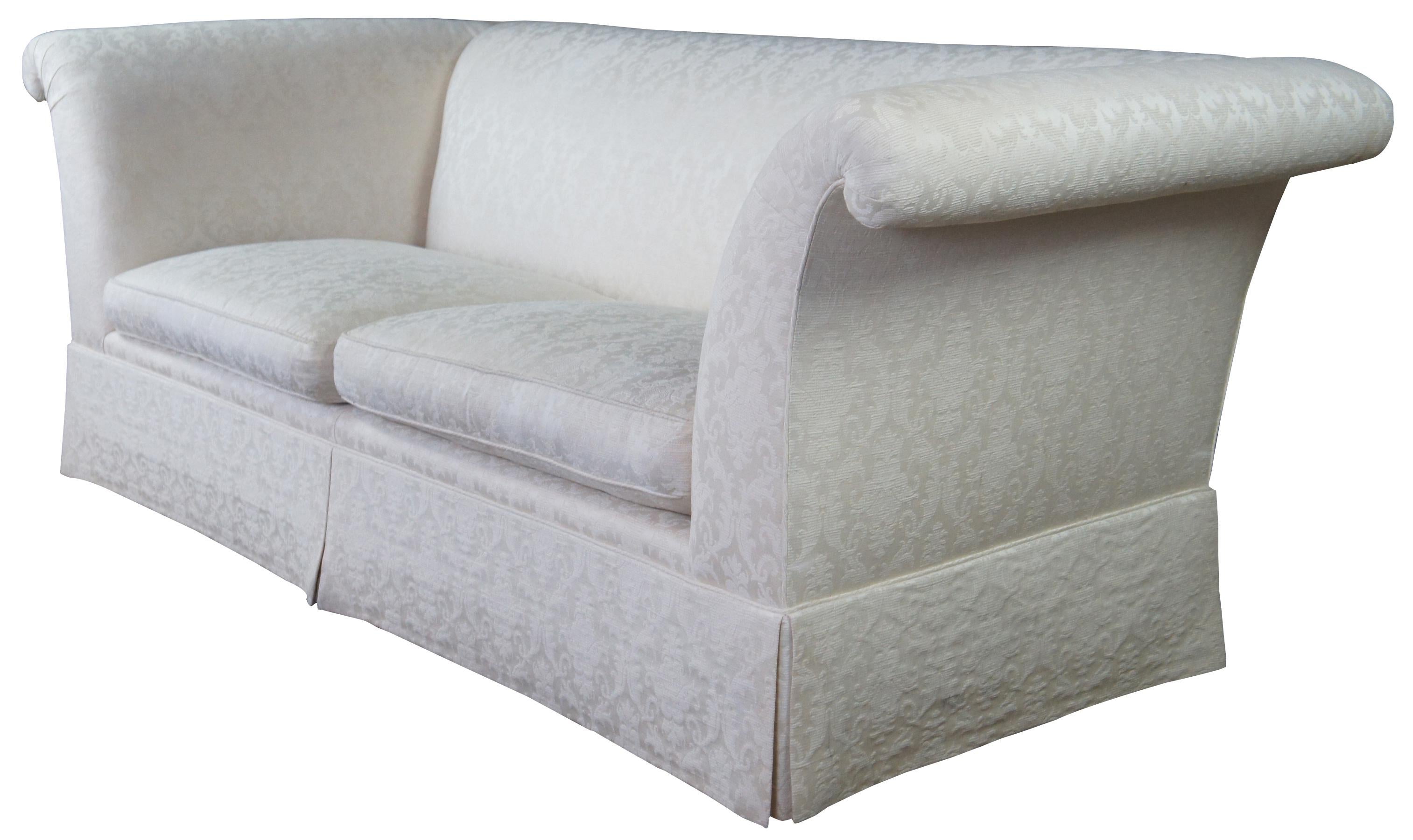 Late 20th Century Vintage Baker Furniture Tuxedo sofa. A rectangular form upholstered in a white French brocade with flared arms.  Includes two removable down filled seat cushions.   
 