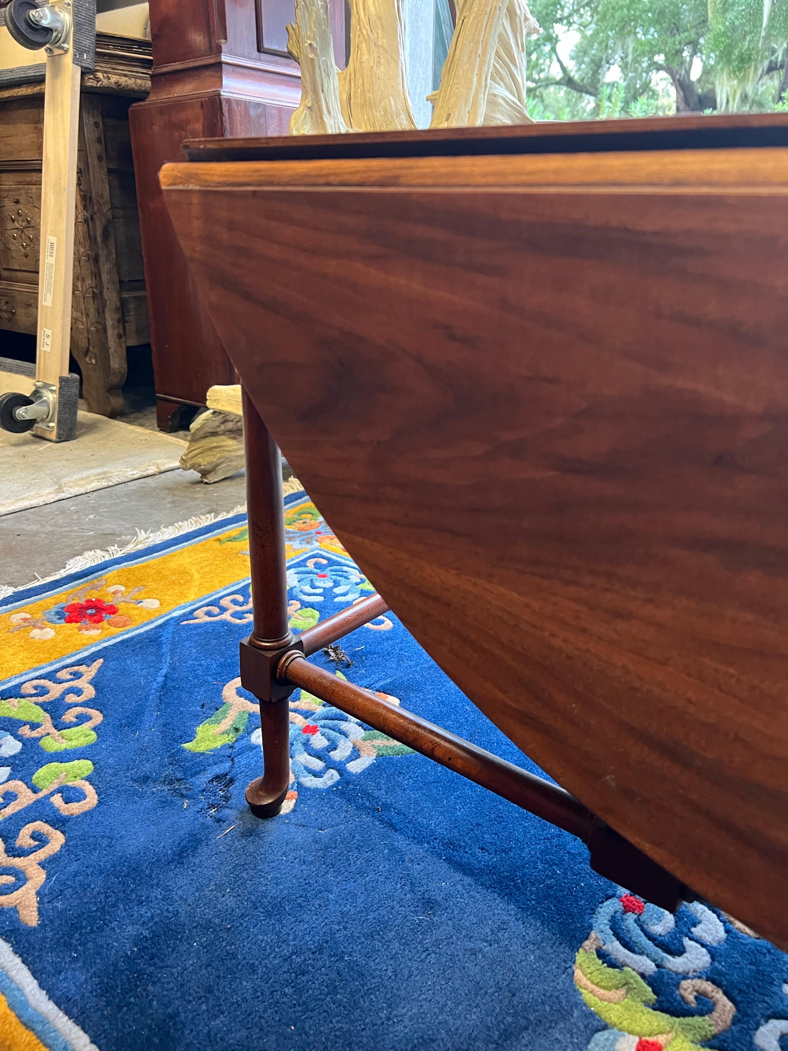 A versatile solid mahogany gate leg cocktail table. Made by one of the premier American furniture makers Baker. A perfect table when you want something not to large but want the option of a much larger table for entertaining. Beautiful graining,
