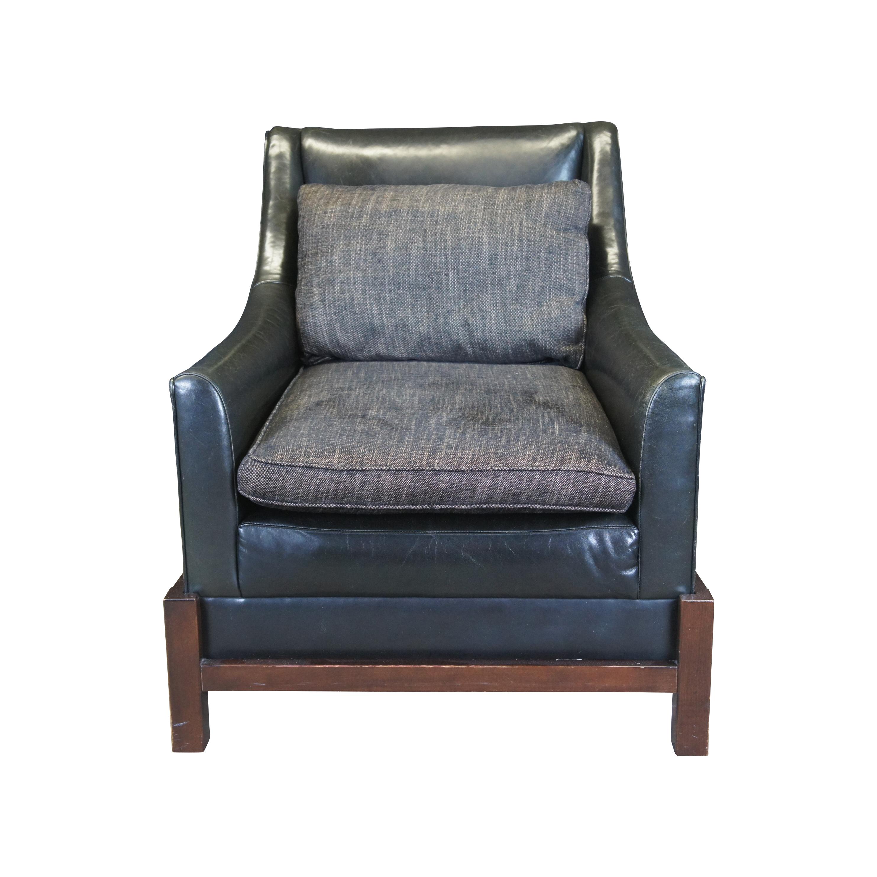 Laura Kirar for Baker Furniture Neue Library Club armchair. Features a black leather frame with swoop arms on an espresso cradle. Features grey seat cushion and back rests. An elegant design that lends well in any modern setting.
DIMENSIONS
32