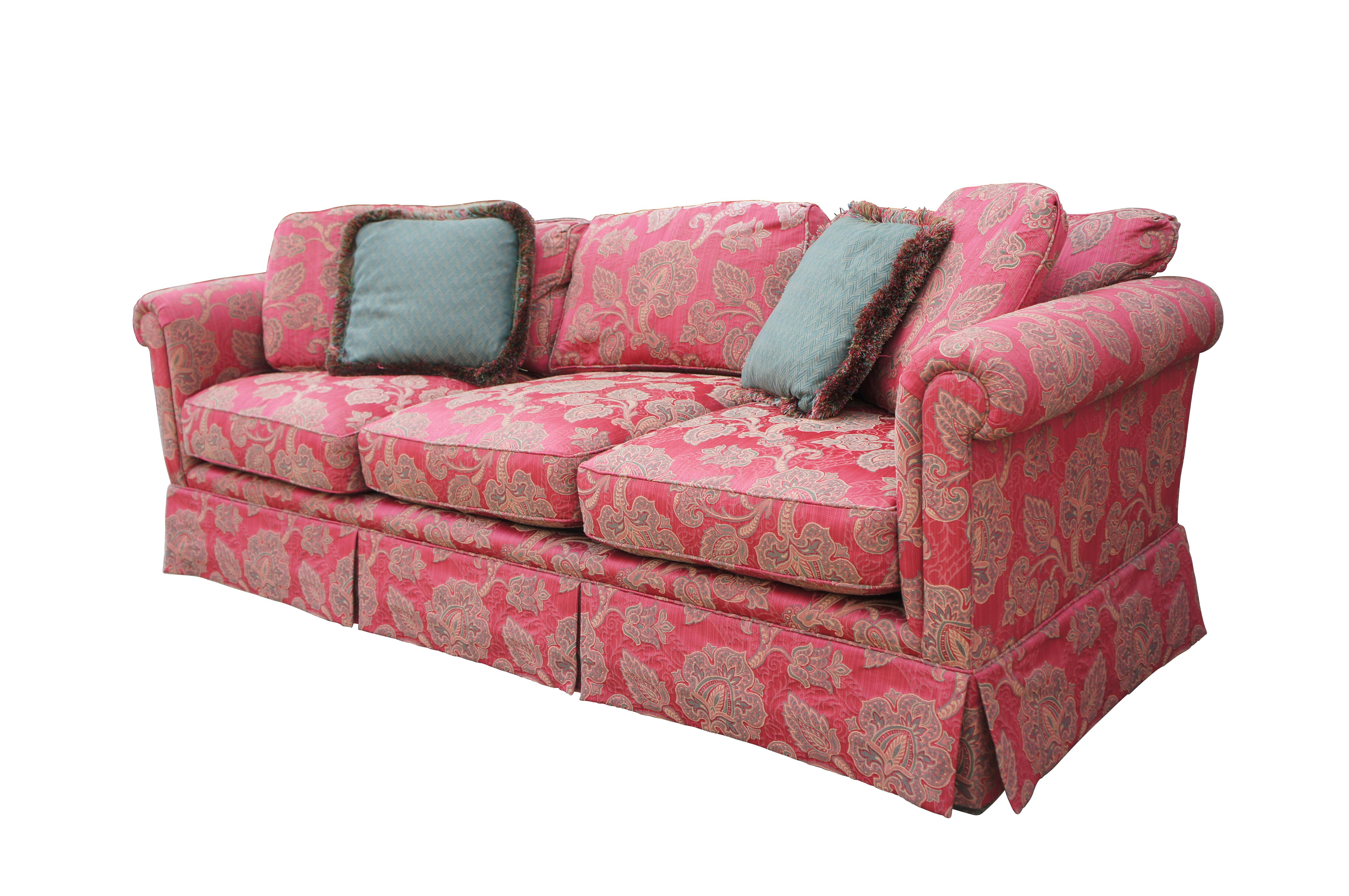 Vintage Baker Furniture three seat sofa or couch featuring red paisley upholstered fabric with rolled arms and skirted base.  Includes two green lumbar throw pillows.

Dimensions:
38