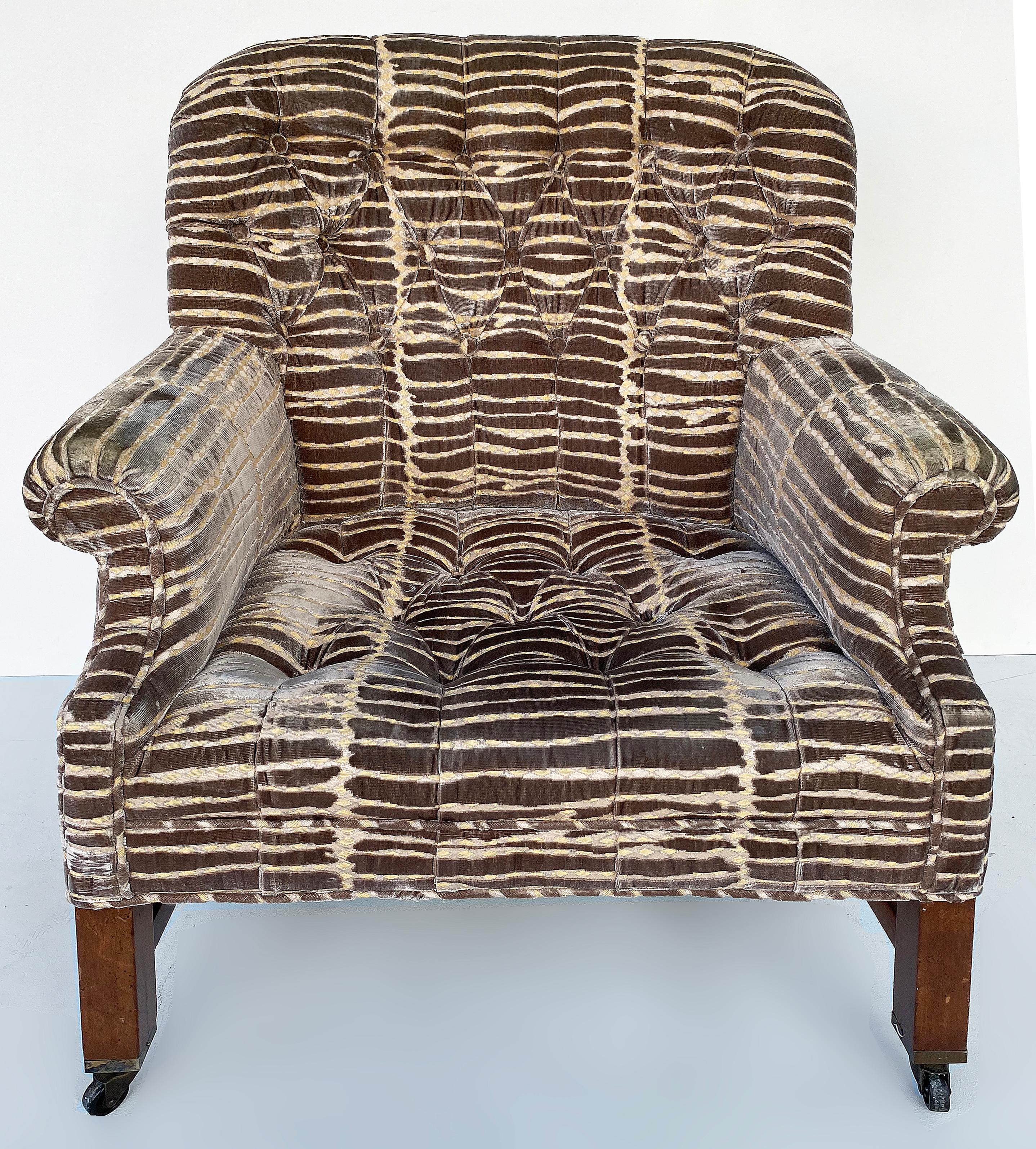 Vintage Baker Gentleman's Club Chairs with Ottoman, Upholstered

Offered for sale is a pair of vintage Baker gentleman's club chairs which have been recently upholstered in a patterned velvet. The chairs are supported by a dark wood frame. The set