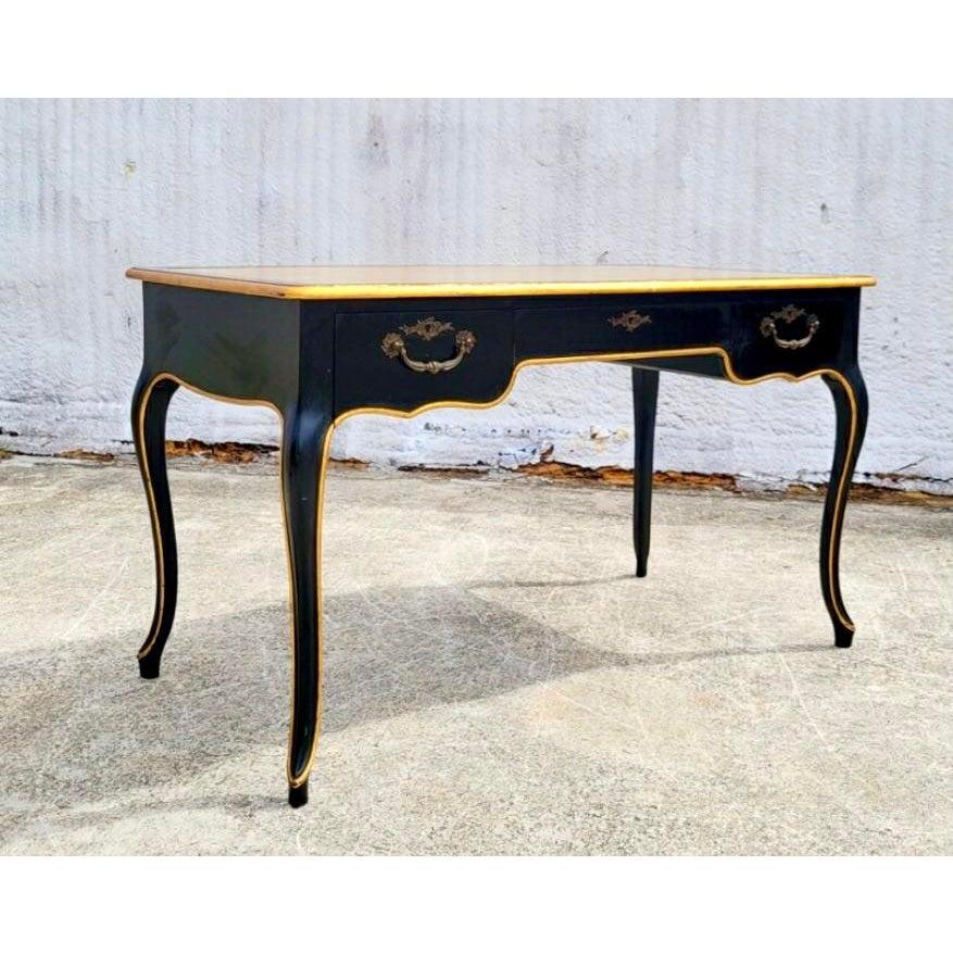 Fantastic vintage Baker writing desk. Gorgeous leather top and gilt touches on a black lacquered desk. Chic cabriolet legs make this a glamorous addition to any room. Acquired from a Palm Beach estate.
