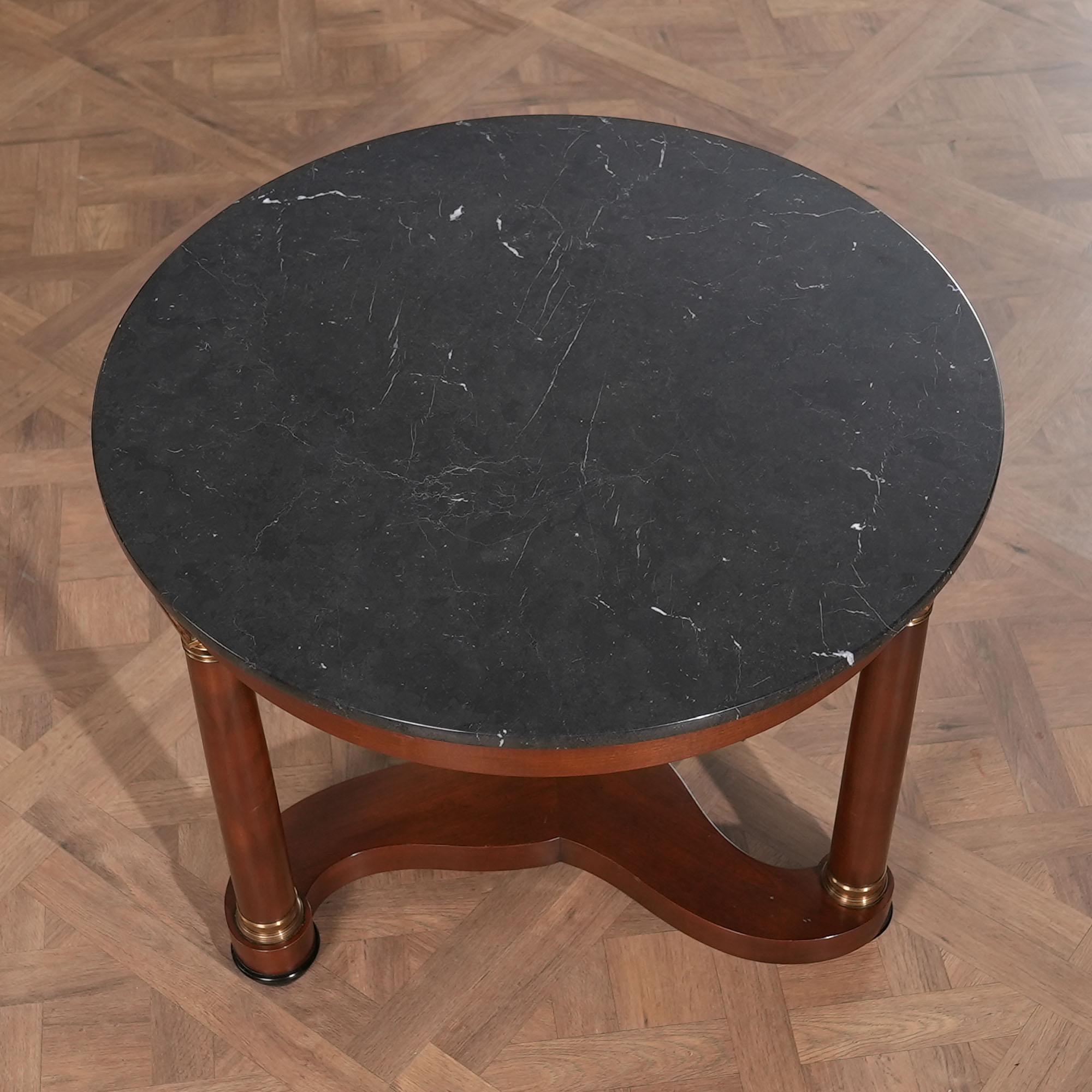 A Vintage Baker Round Table which will be the focal point of any room in which it is placed. From the beautiful marble top to the sturdy and lovely turned columns and down to the mesmerizing center stretcher this table has all of the standout