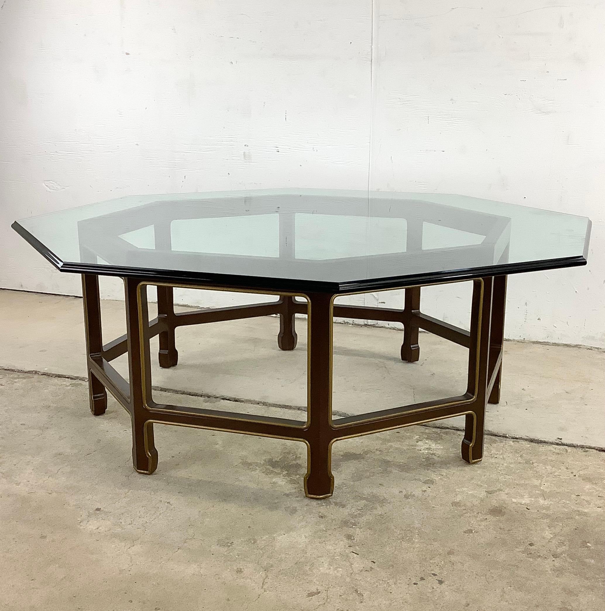 This stunning vintage modern octagonal coffee table features unique Baker style lacquer design and is topped with thick beveled glass. The eight-sided configuration of this striking Kindel Furniture attributed coffee table makes this an eye-catching